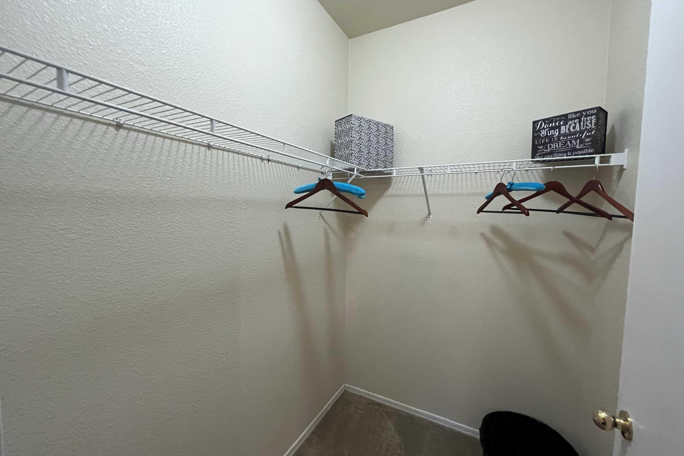 A small, organized closet with white walls