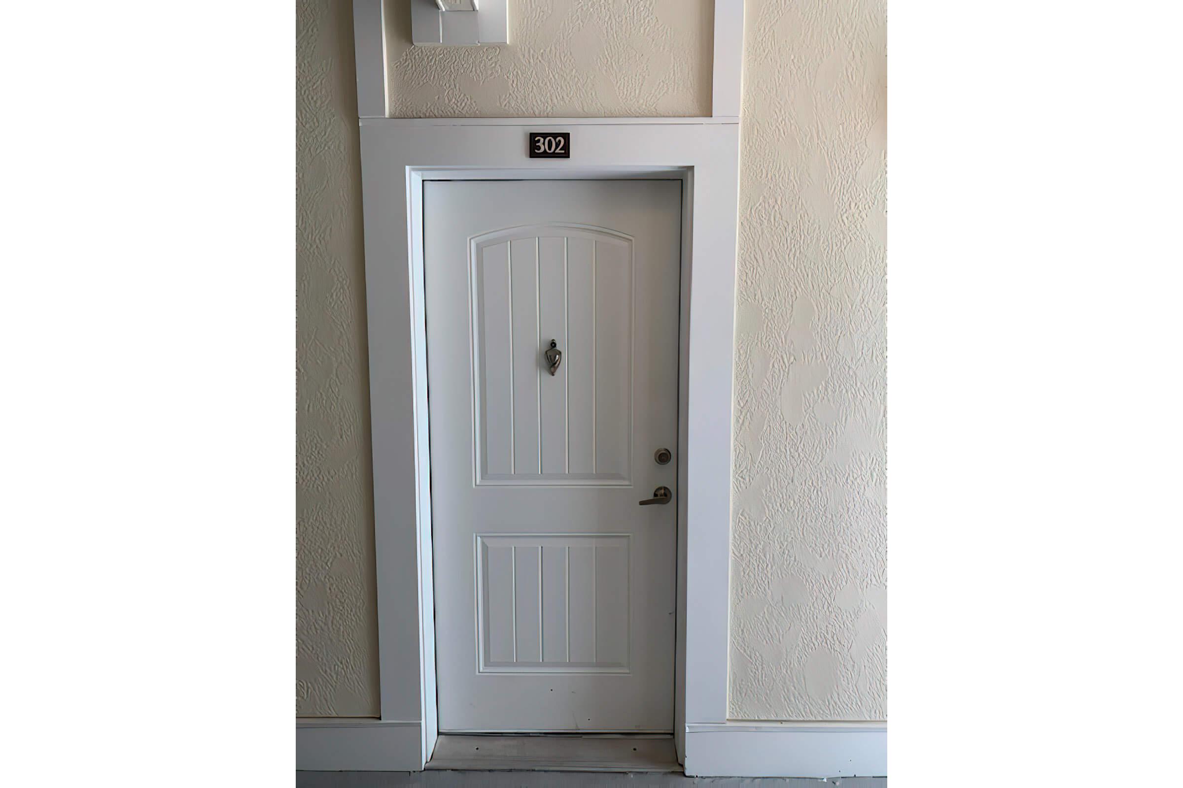 a cat sitting on top of a door