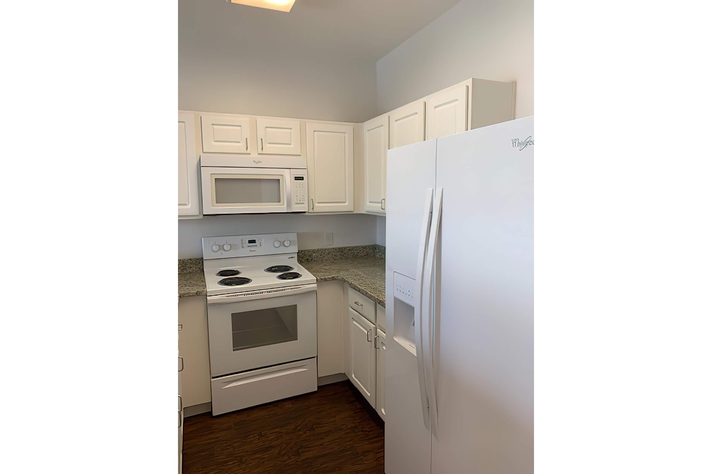 a kitchen with a stove and a refrigerator