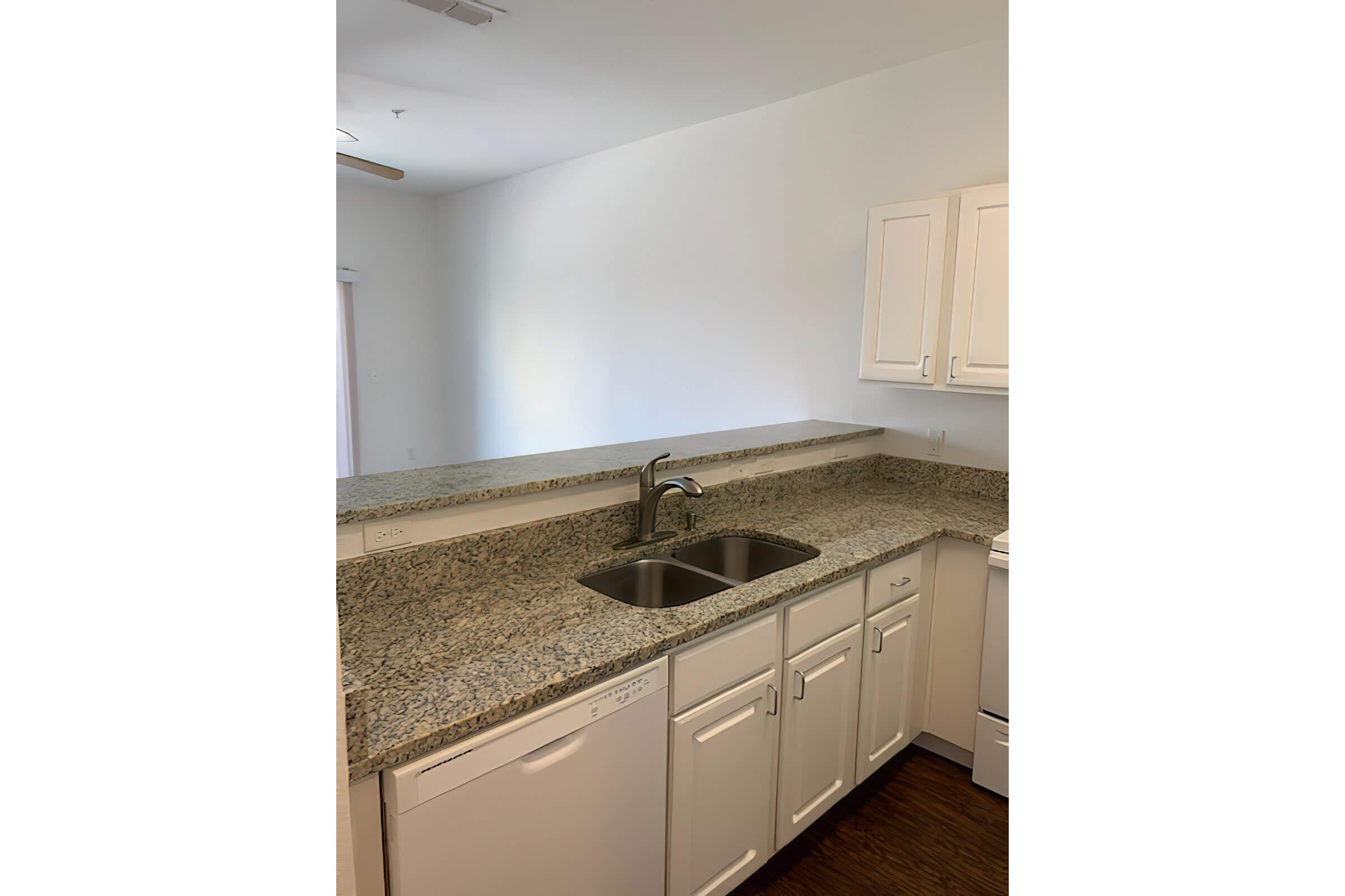 a kitchen with a sink and a mirror