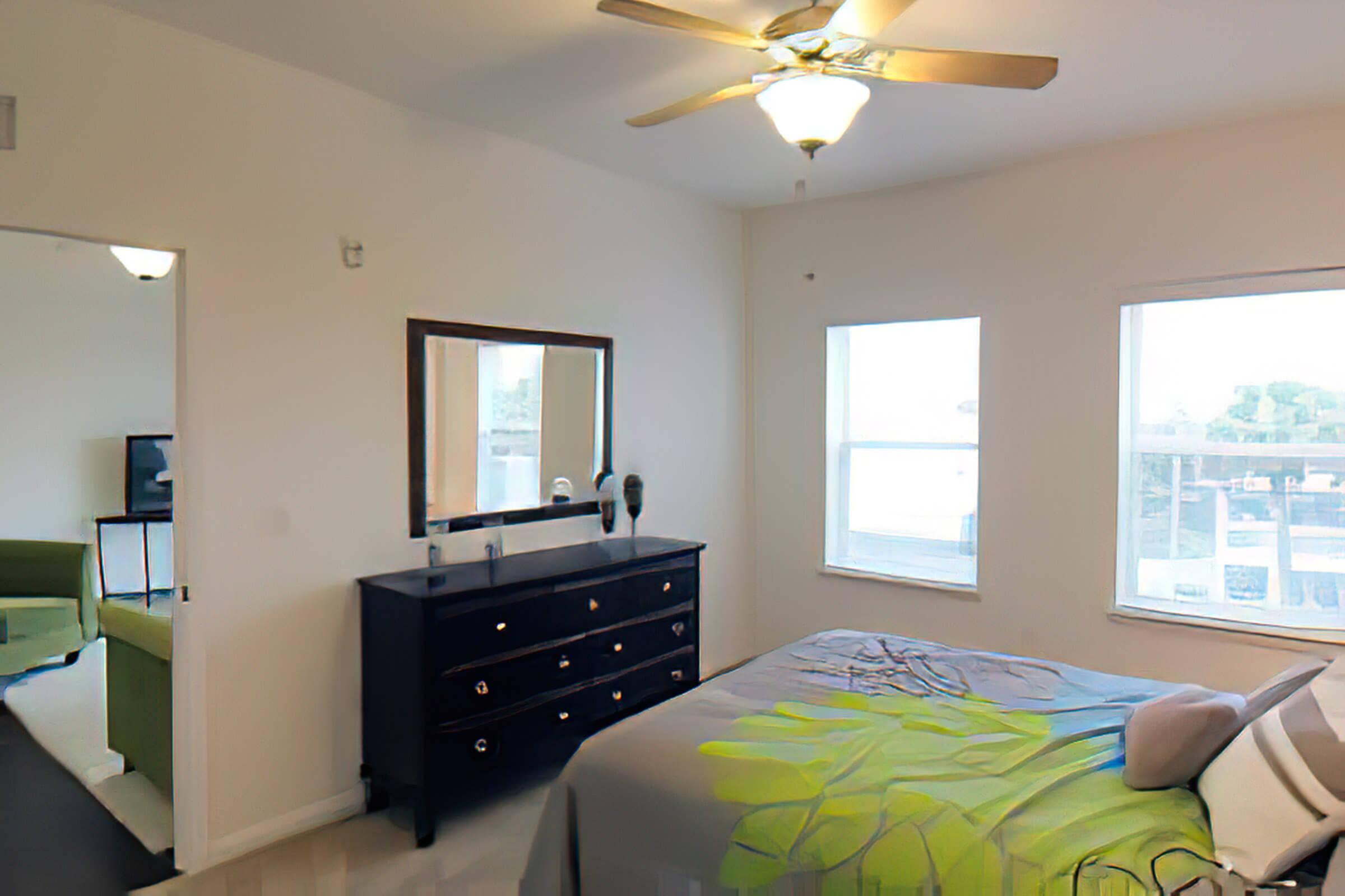 a bedroom with a bed and desk in a room