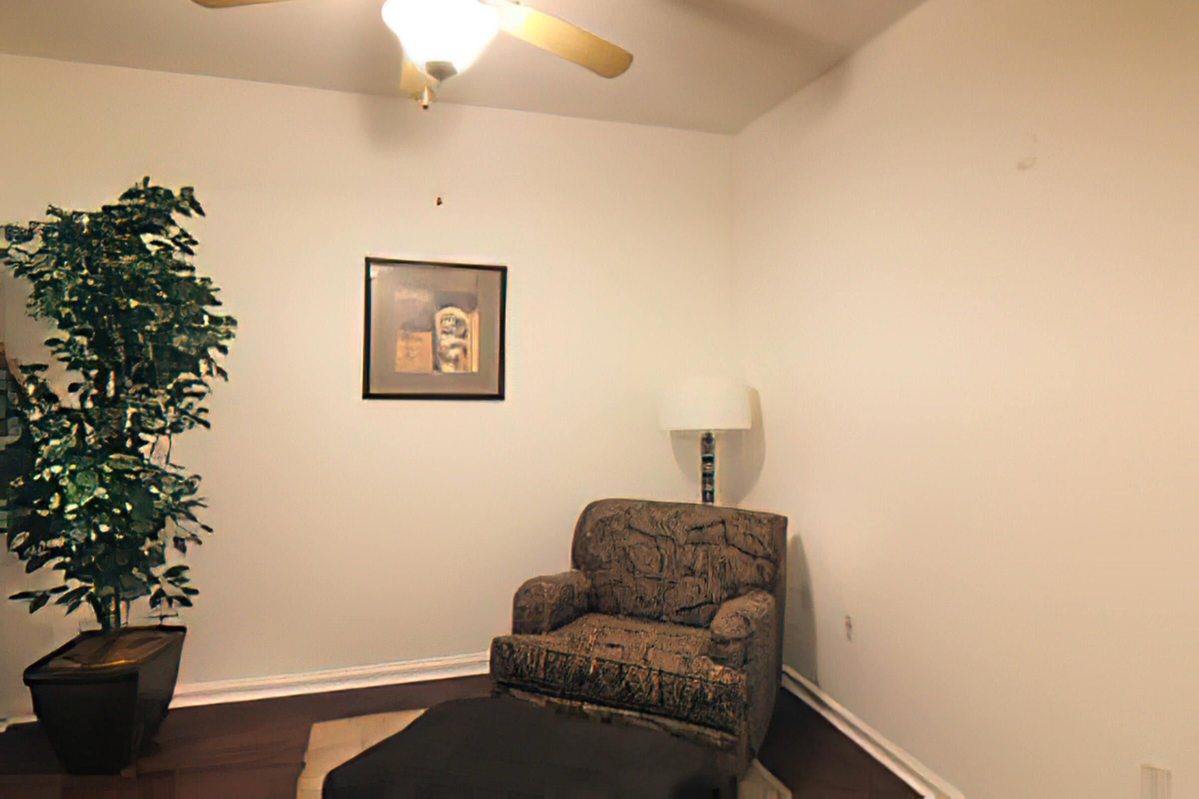 a living room filled with furniture and a lamp