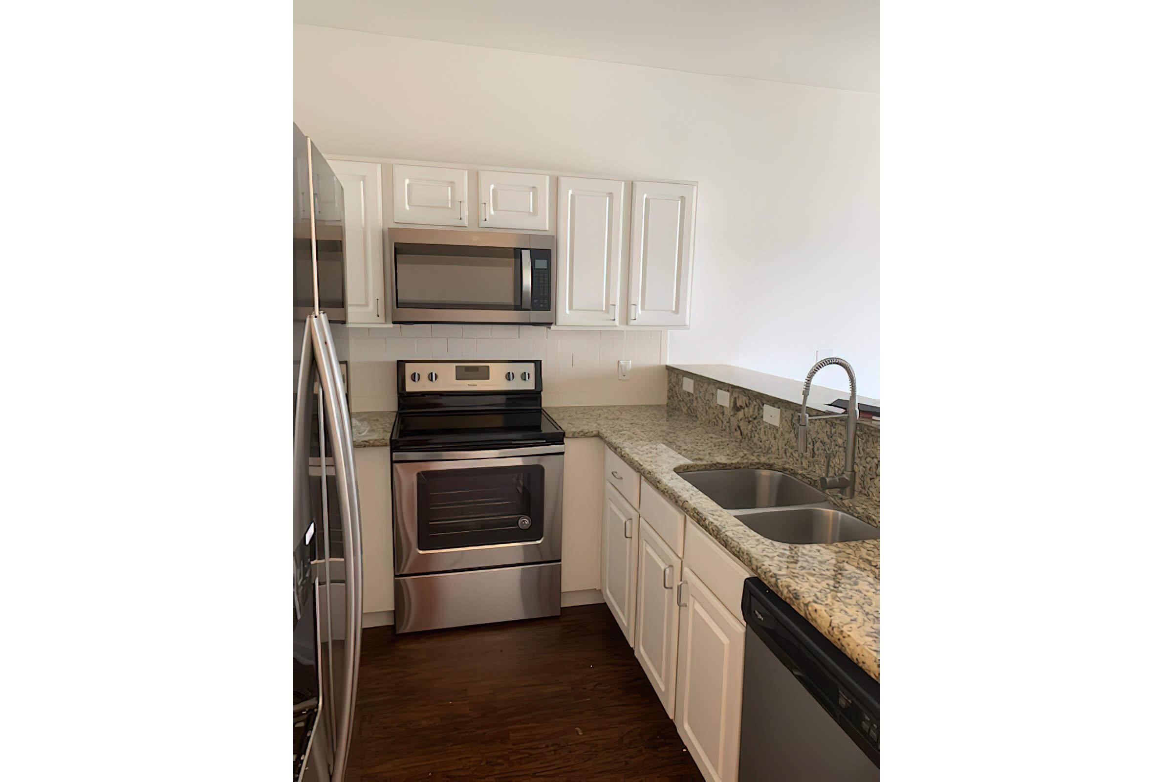 a kitchen with stainless steel appliances and wooden cabinets