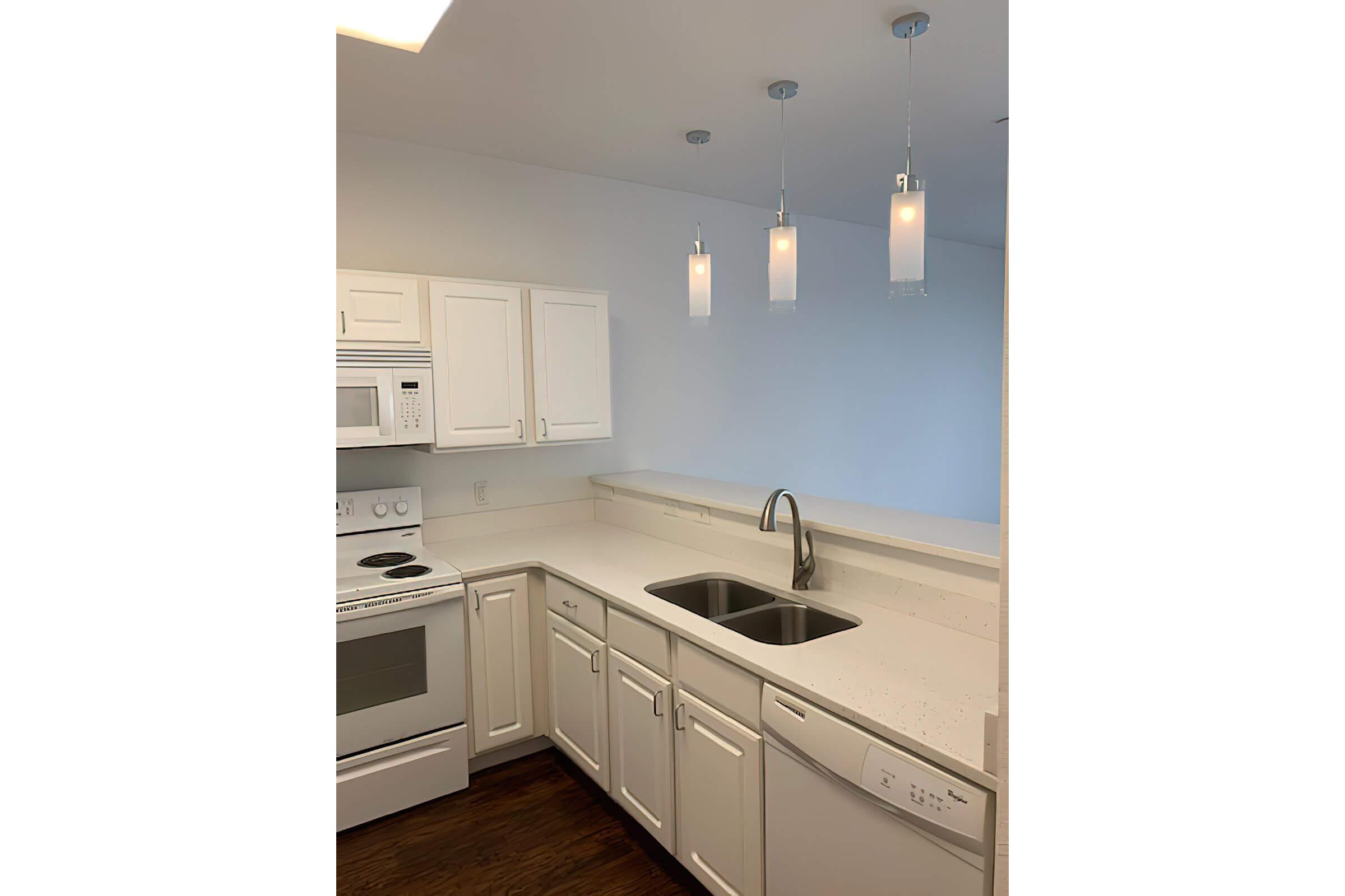 a kitchen with a sink and a mirror