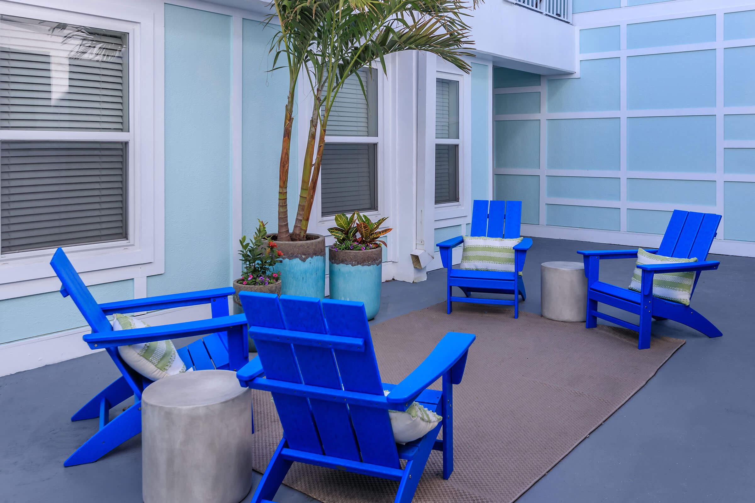 a blue chair sitting in front of a building