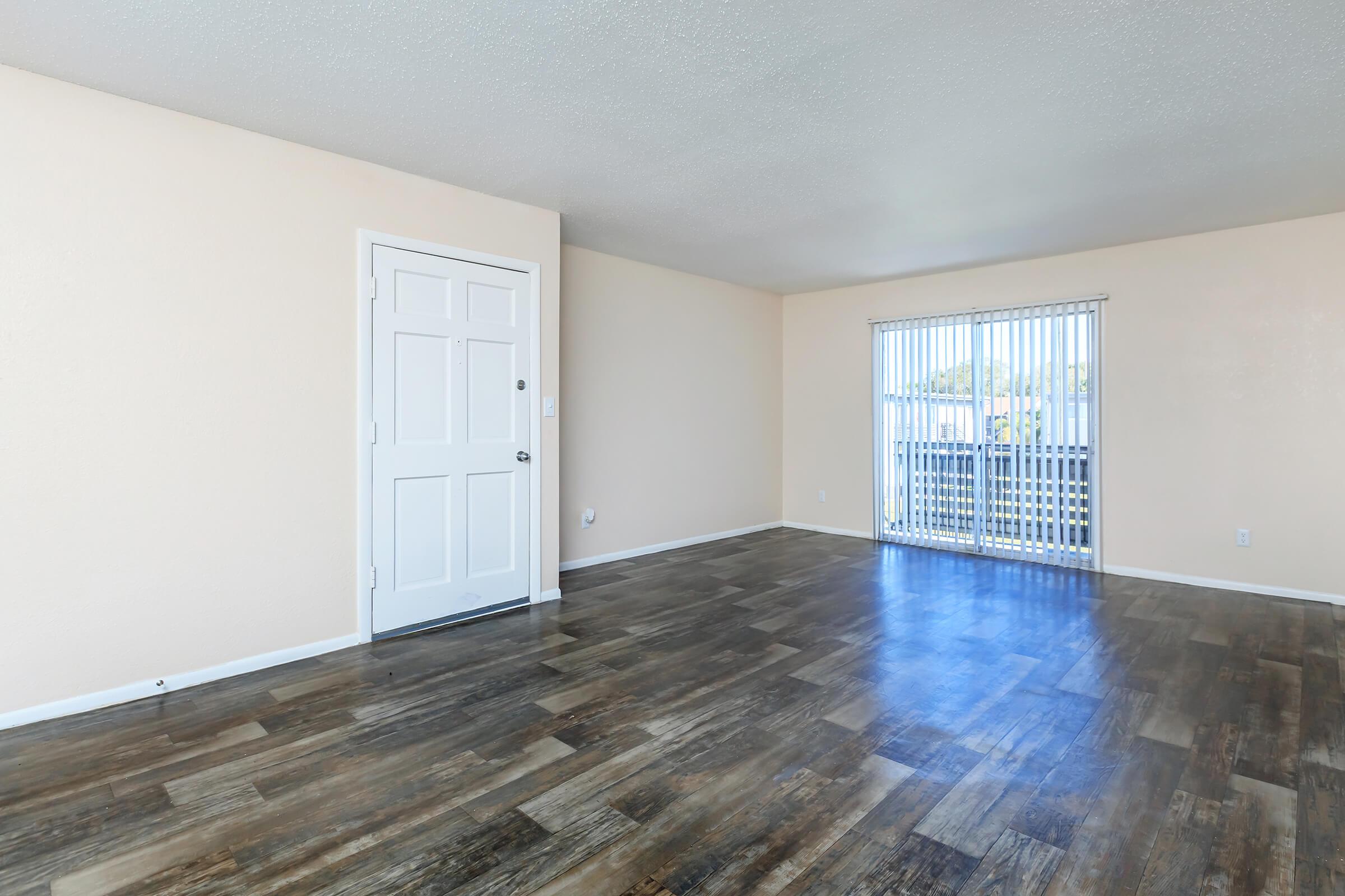 LUXURY WOOD LAMINATE FLOORING IN YOUR LIVING SPACE AT THE CROSSINGS AT 66TH APARTMENTS