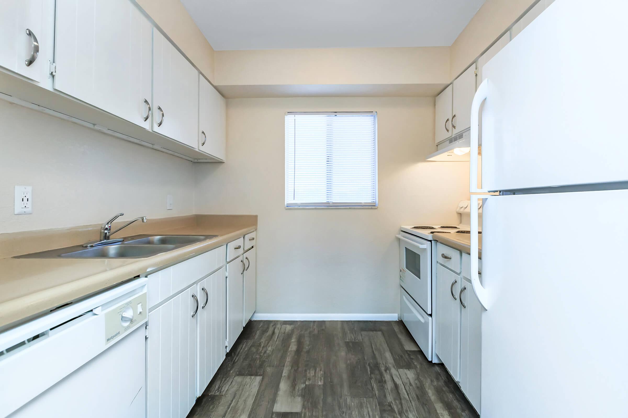 a kitchen with a sink and a refrigerator