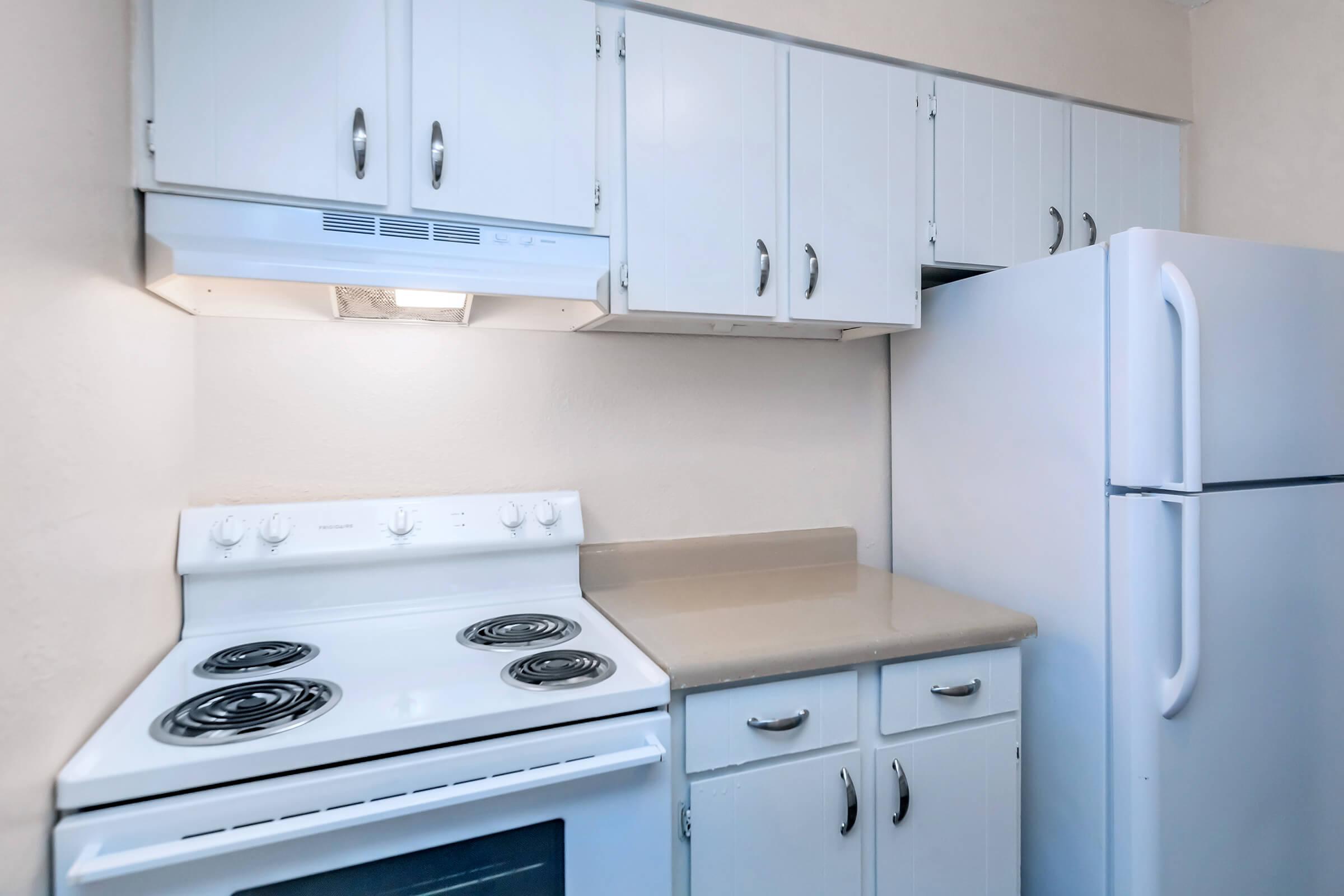 a kitchen with a stove top oven sitting inside of a refrigerator