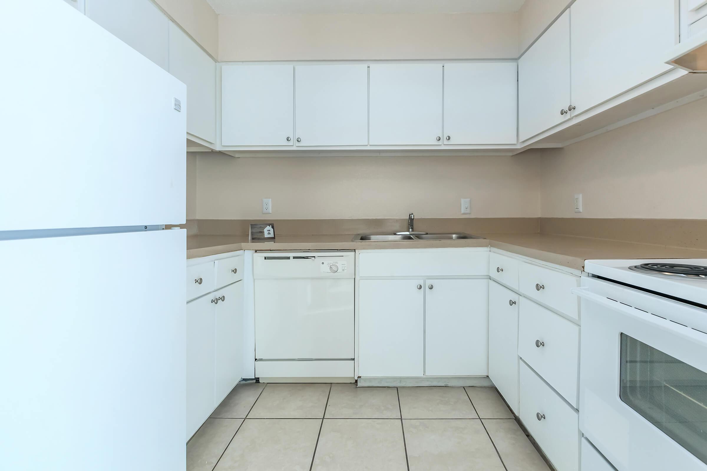 a kitchen with a stove and a refrigerator