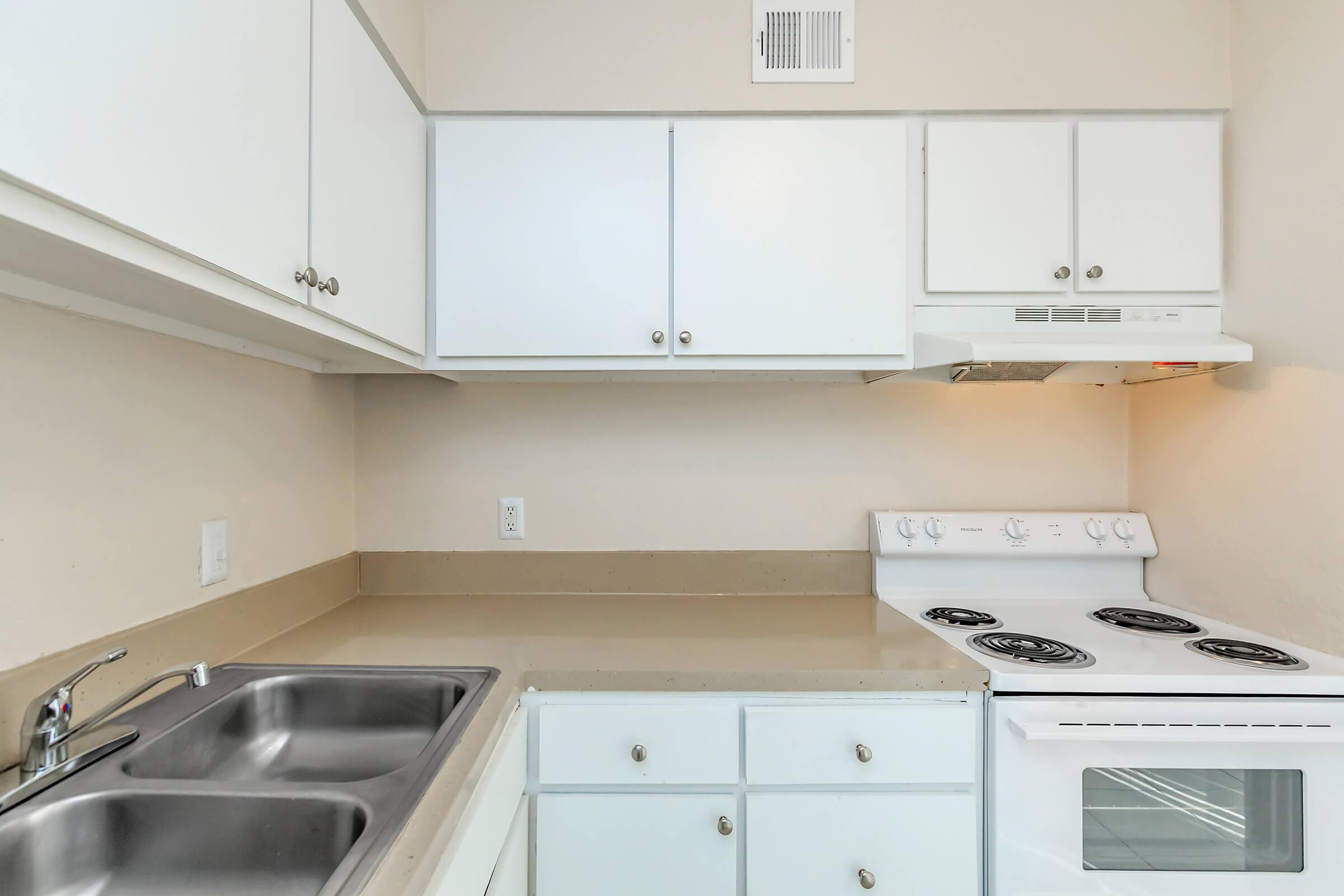 a stove top oven sitting inside of a kitchen