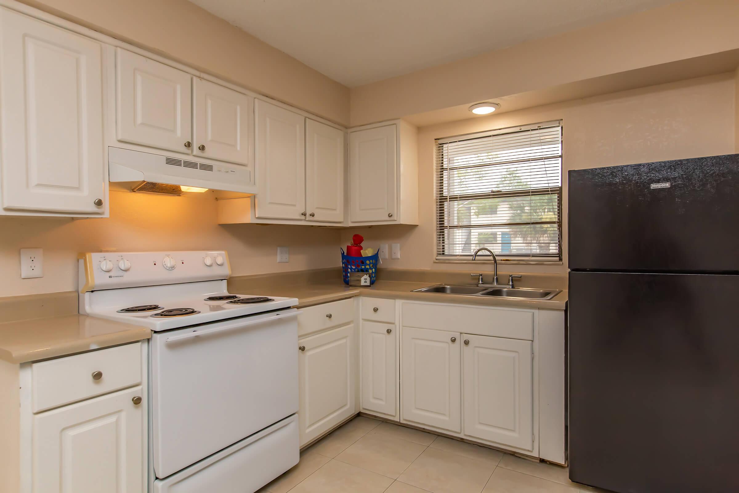 a kitchen with a stove and a refrigerator