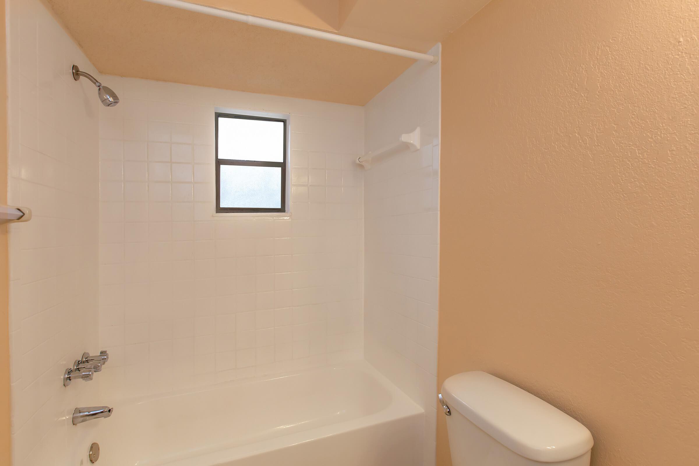 a small rest room with a sink and a shower