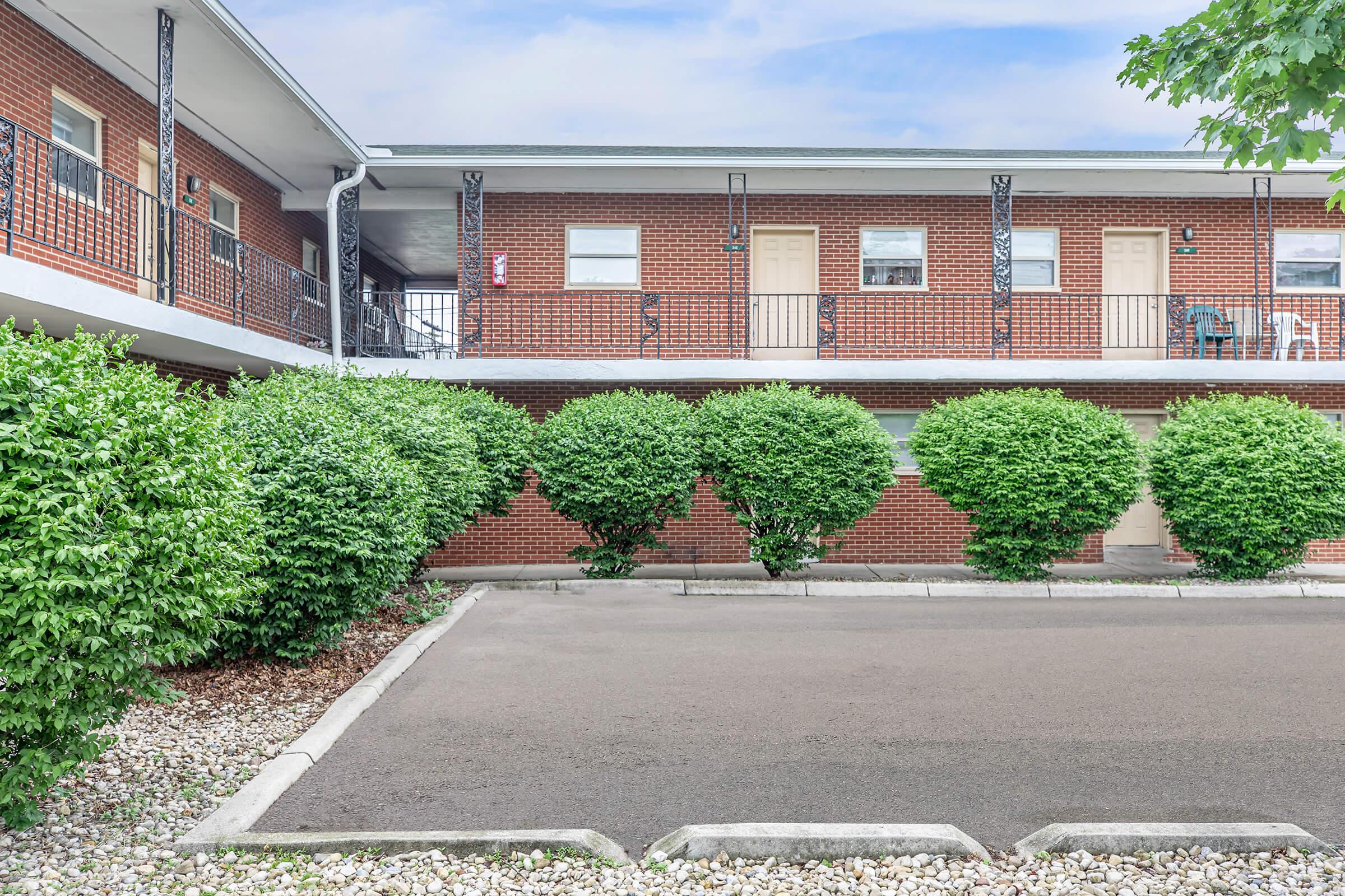 an empty road in front of a brick building