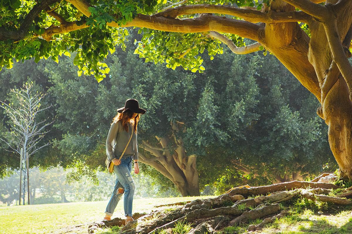 a man standing next to a tree