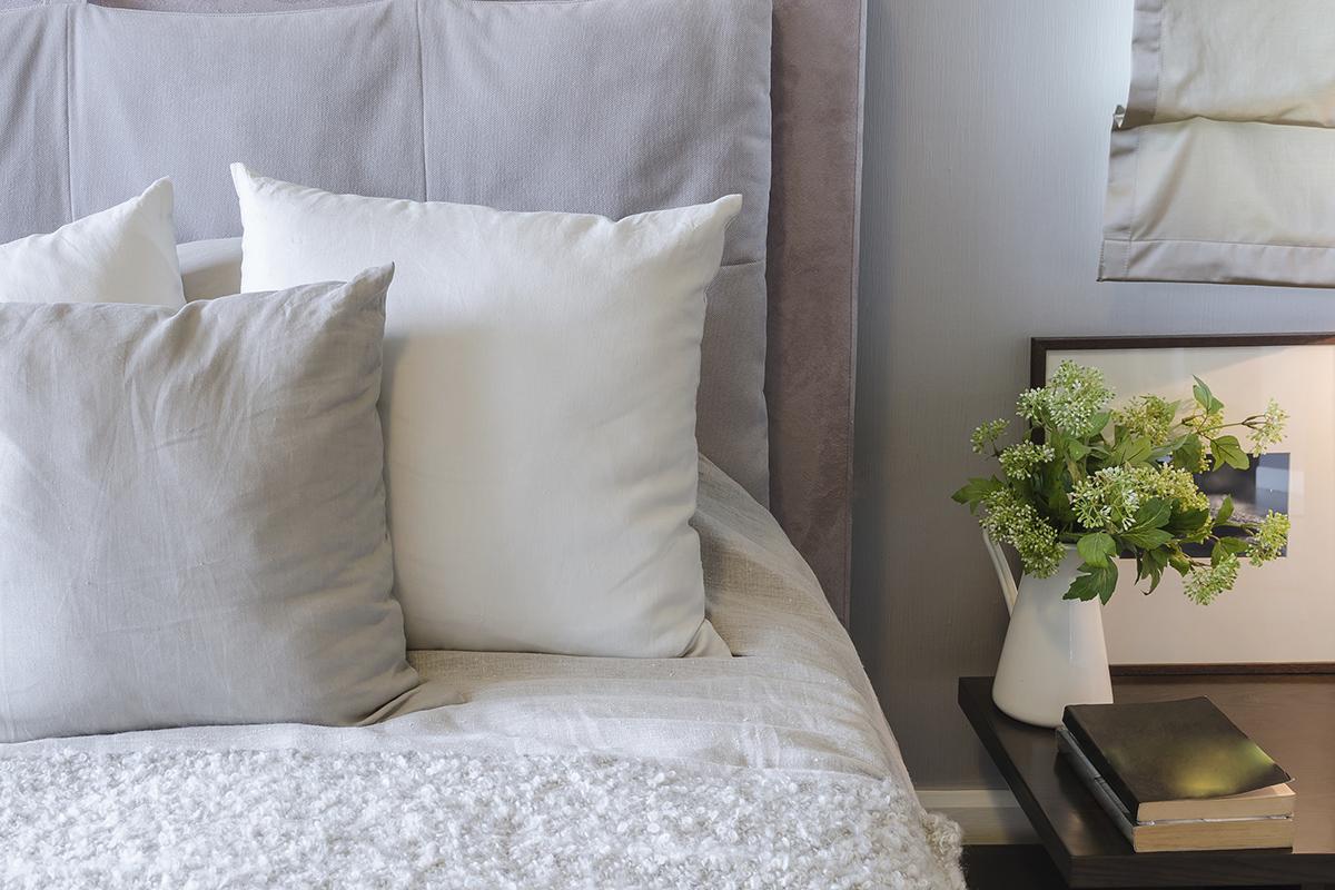 a large white bed sitting in a room