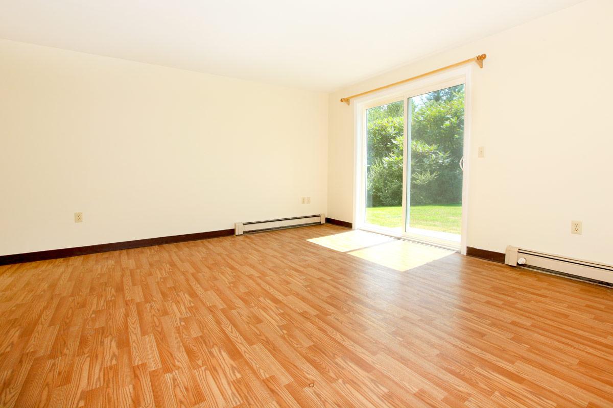 a large empty room with a wood floor