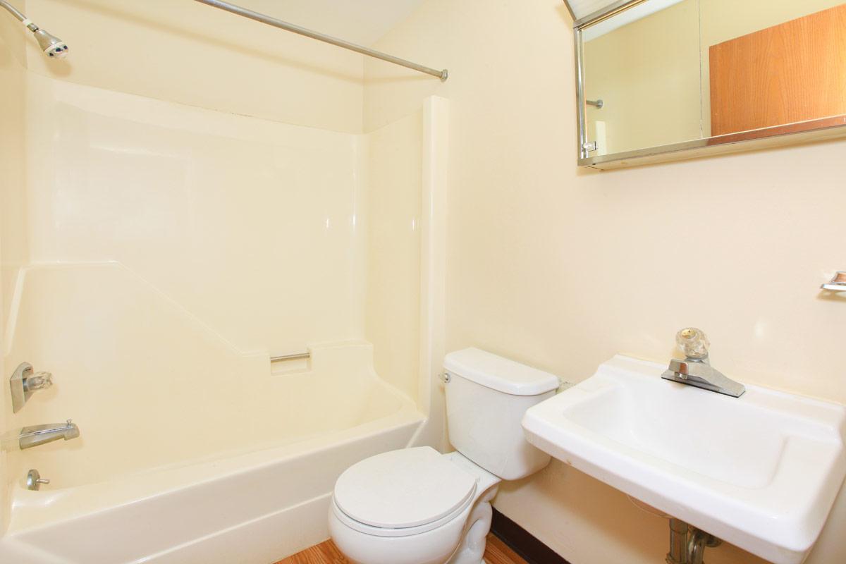 a white tub sitting next to a sink