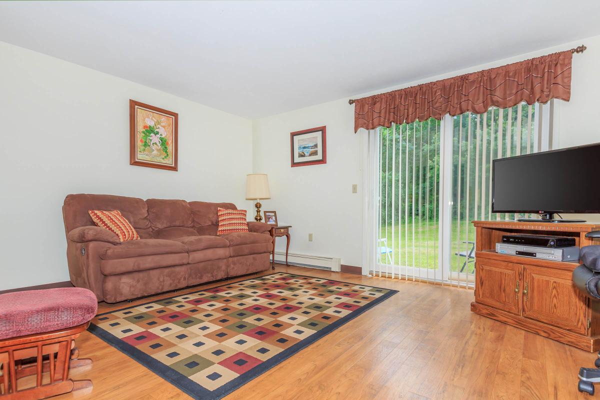 a living room filled with furniture and a flat screen tv