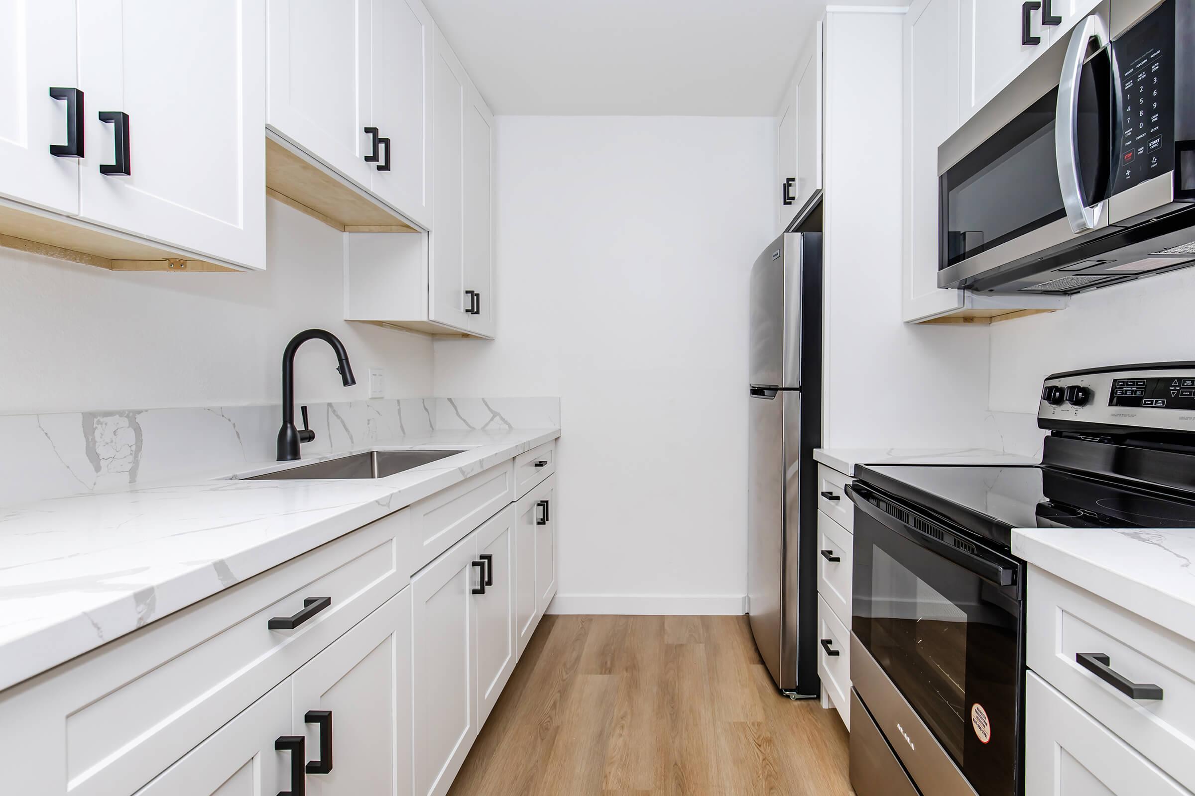 a stove top oven sitting inside of a kitchen