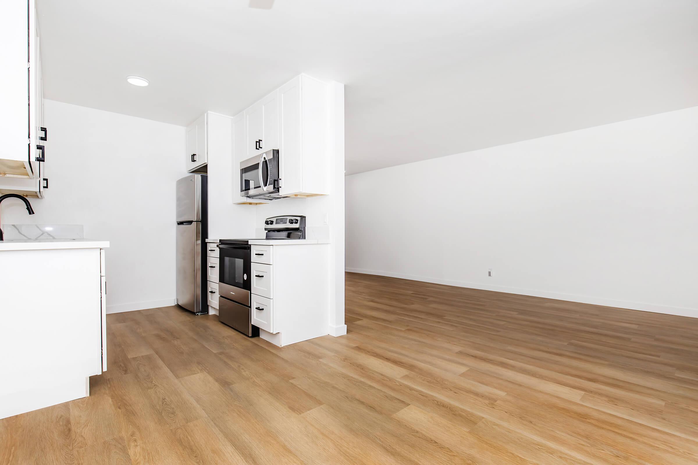 a kitchen with a wood floor