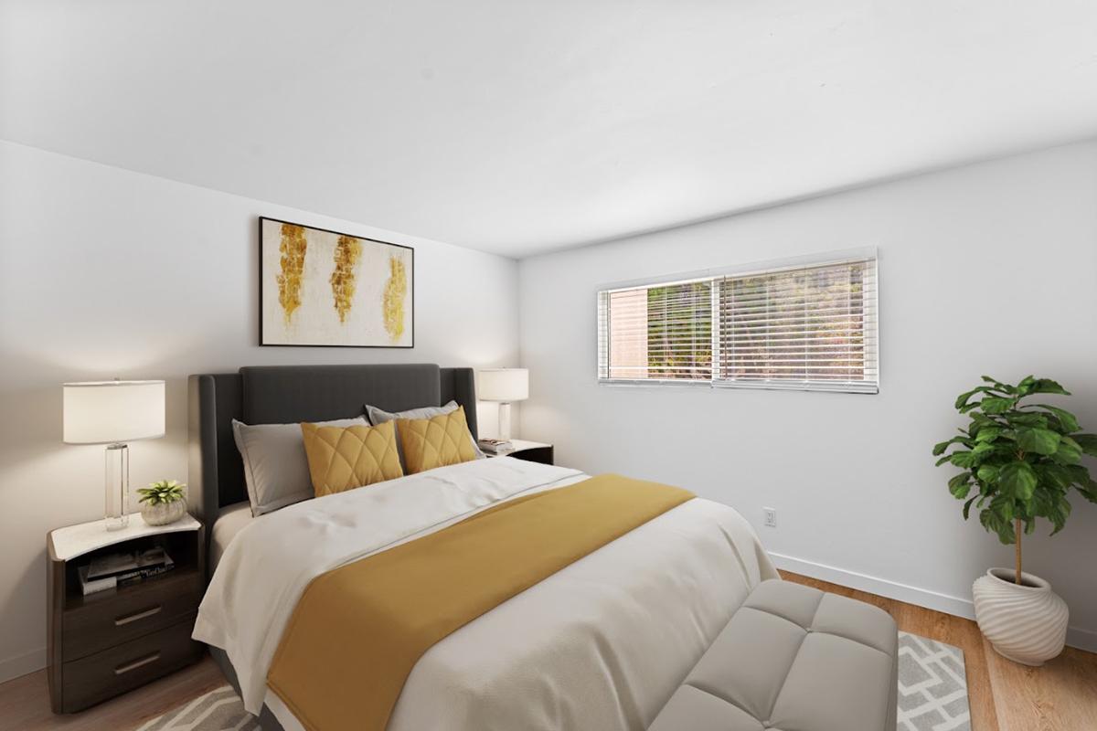 a bedroom with a bed and desk in a hotel room