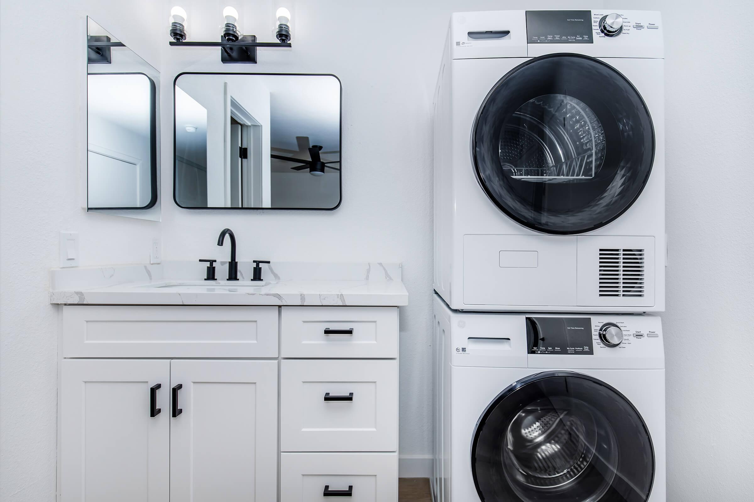 a kitchen with a sink and a mirror