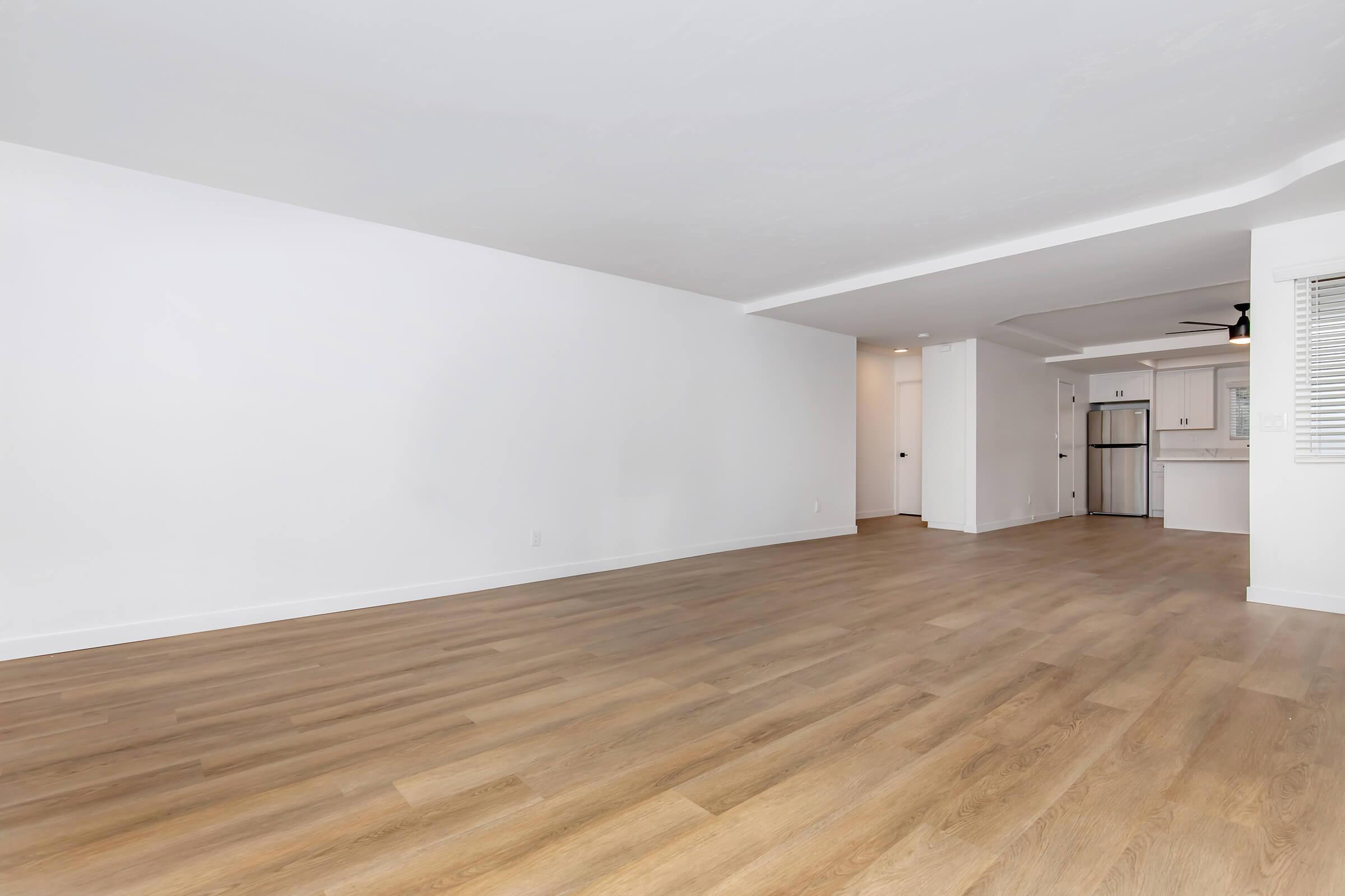 a large empty room with a wooden floor