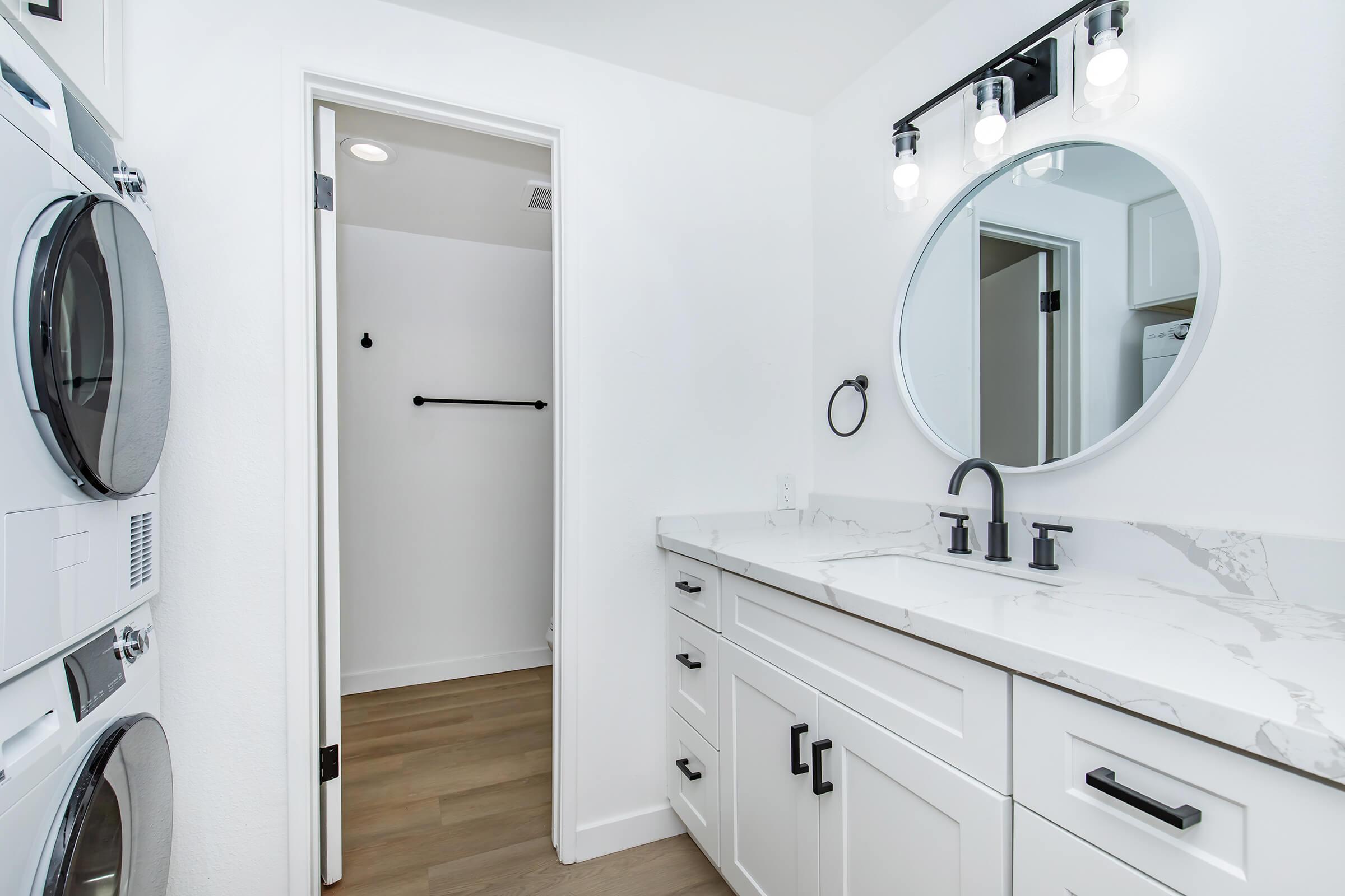 a kitchen with a sink and a mirror