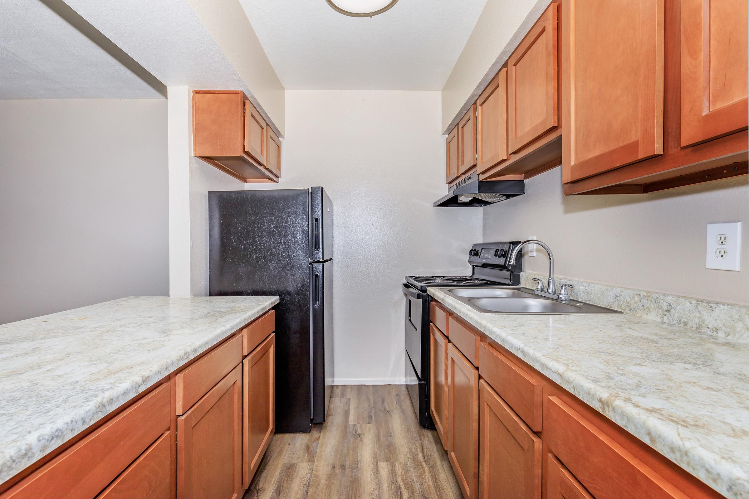 a kitchen with stainless steel appliances and wooden cabinets