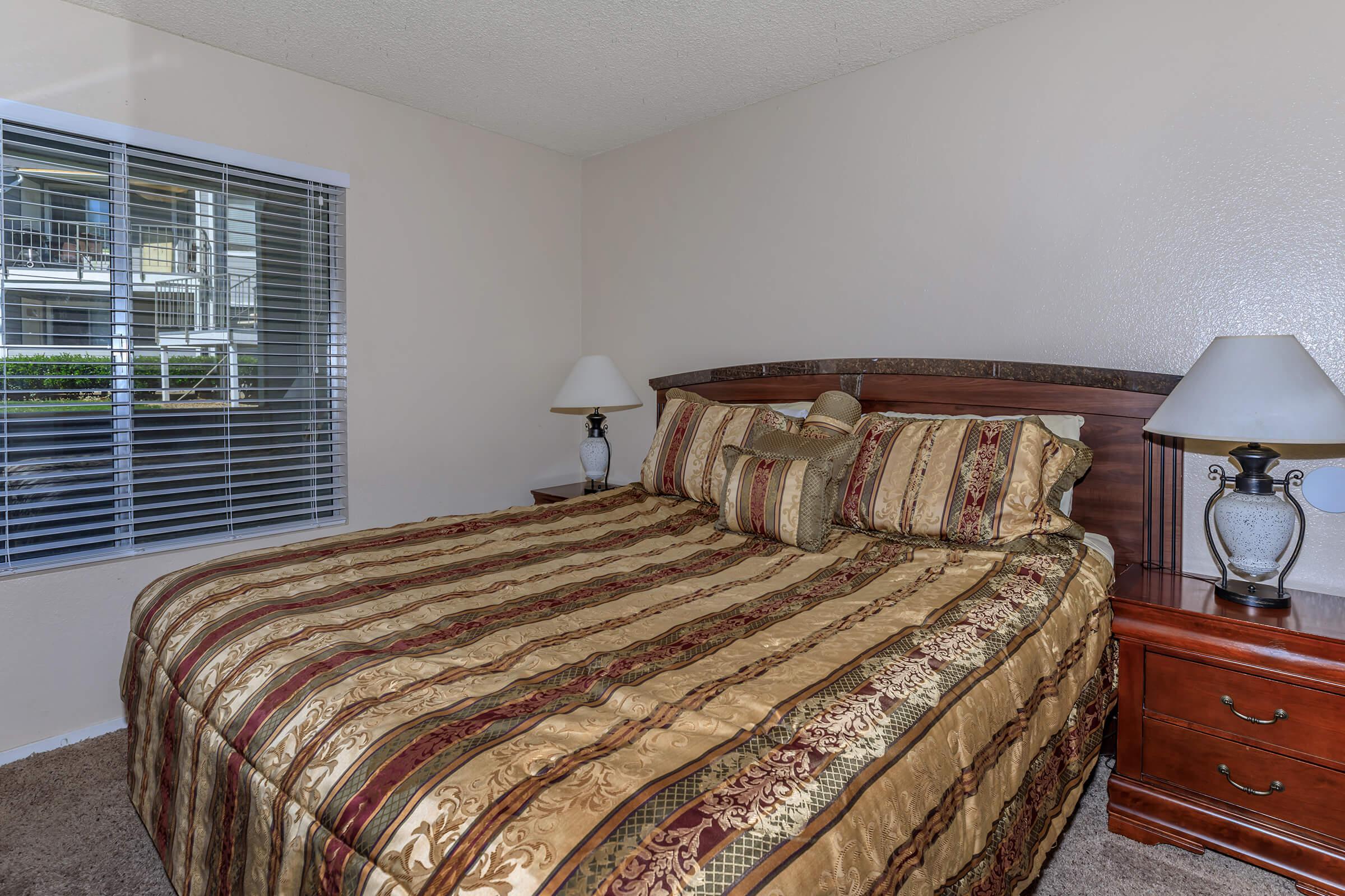 a bedroom with a large bed in a hotel room