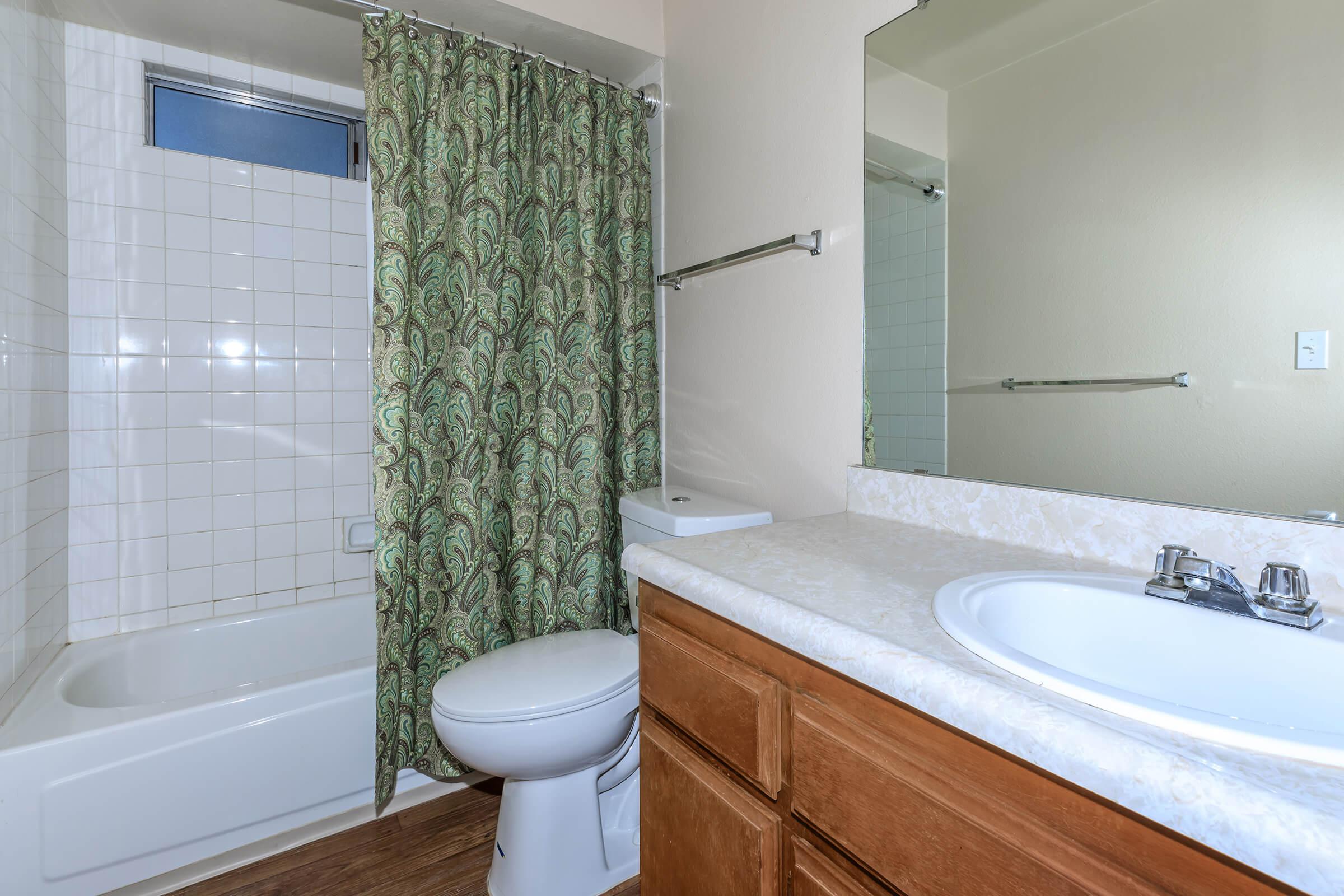 a white tub sitting next to a sink