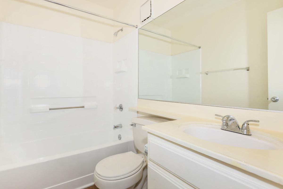 a large white tub sitting next to a sink
