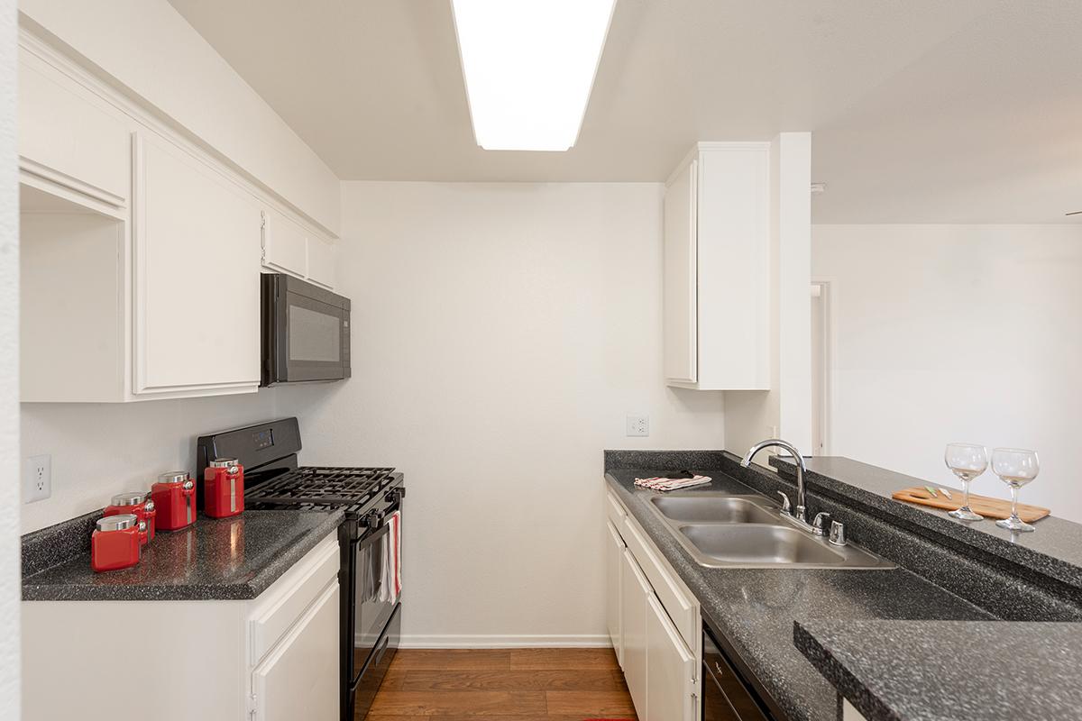 a kitchen with a stove sink and refrigerator