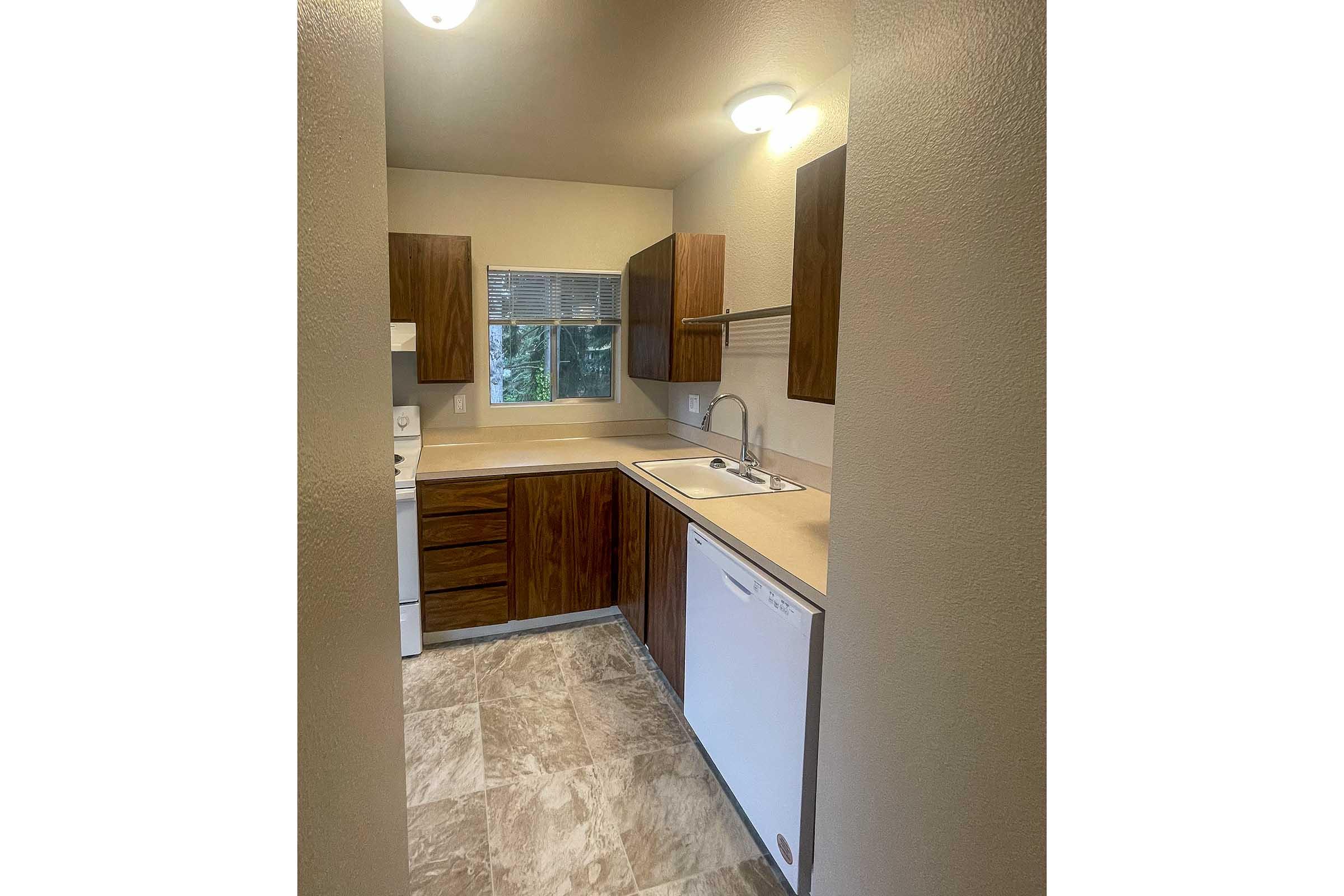 a kitchen with a sink and a mirror