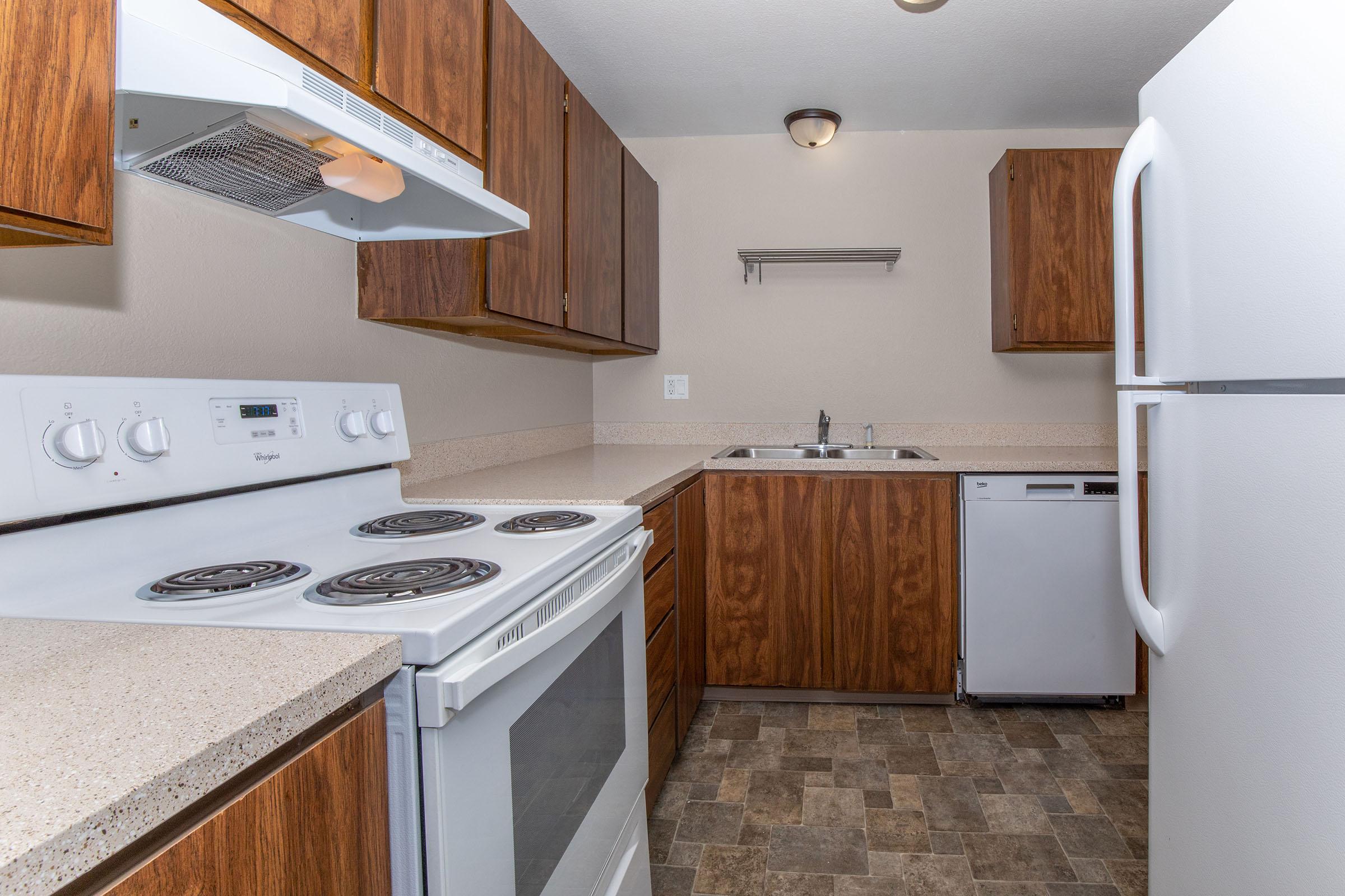 a kitchen with a stove sink and refrigerator