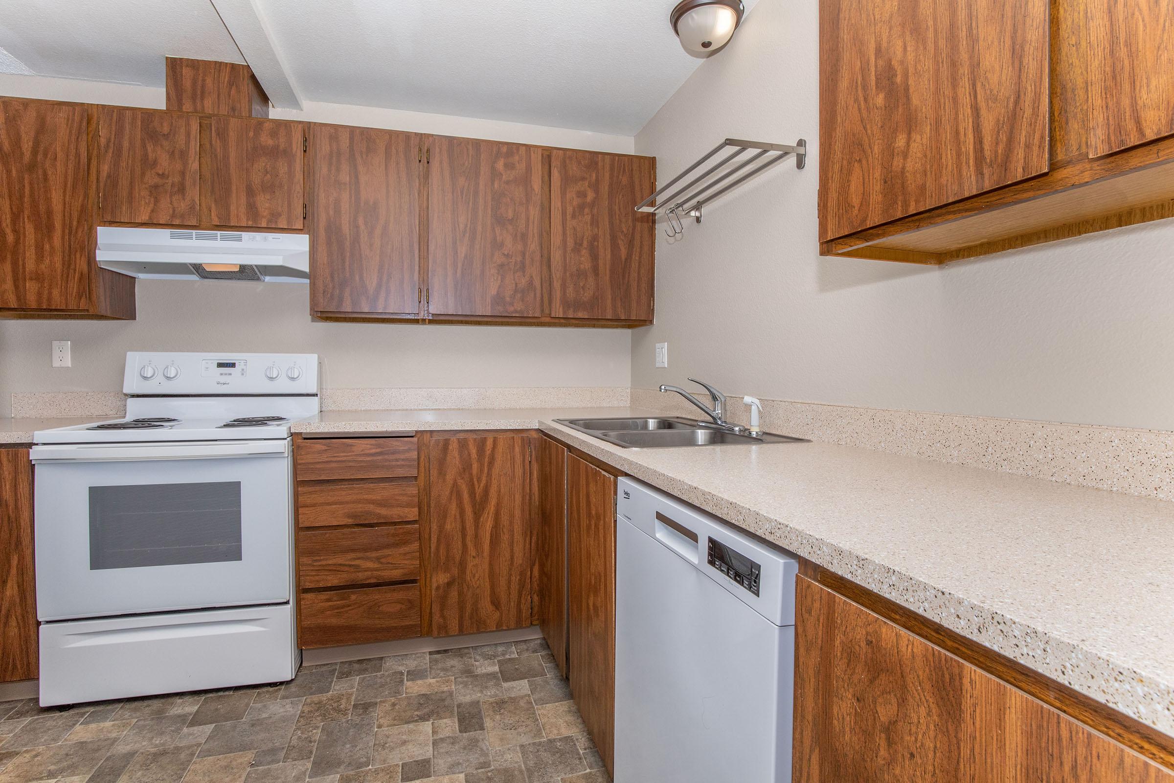 a kitchen with wooden cabinets and a microwave