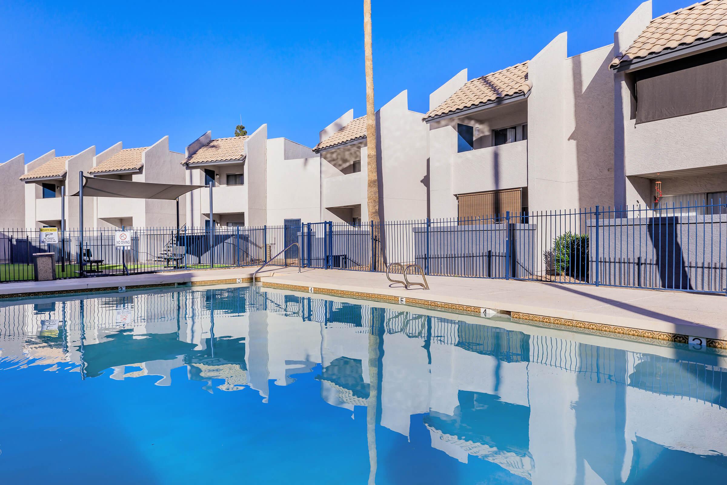 The dazzling pool at Rise Thunderbird surrounded by the apartments