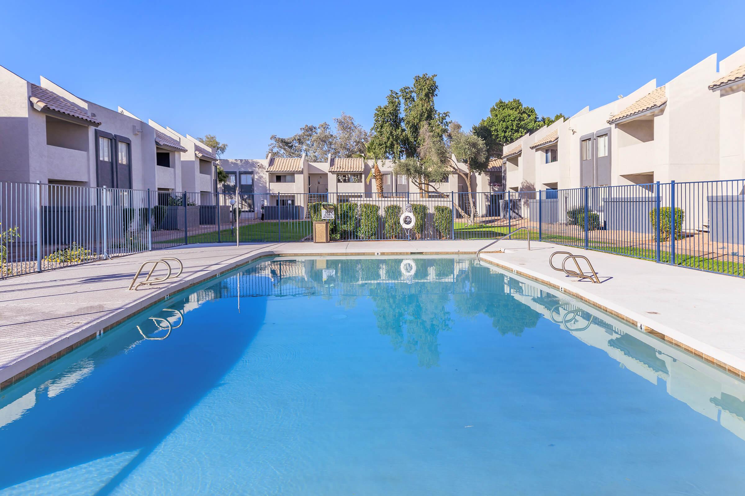 The large pool surrounded by apartments at Rise Thunderbird.