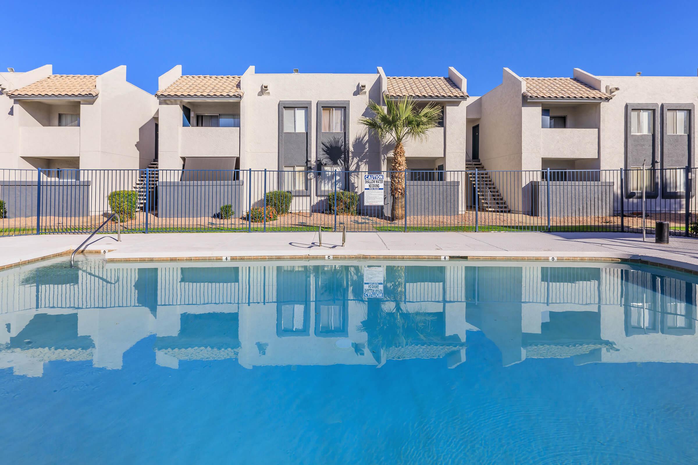 The sparkling pool surrounded by the apartments at Rise Thunderbird. 