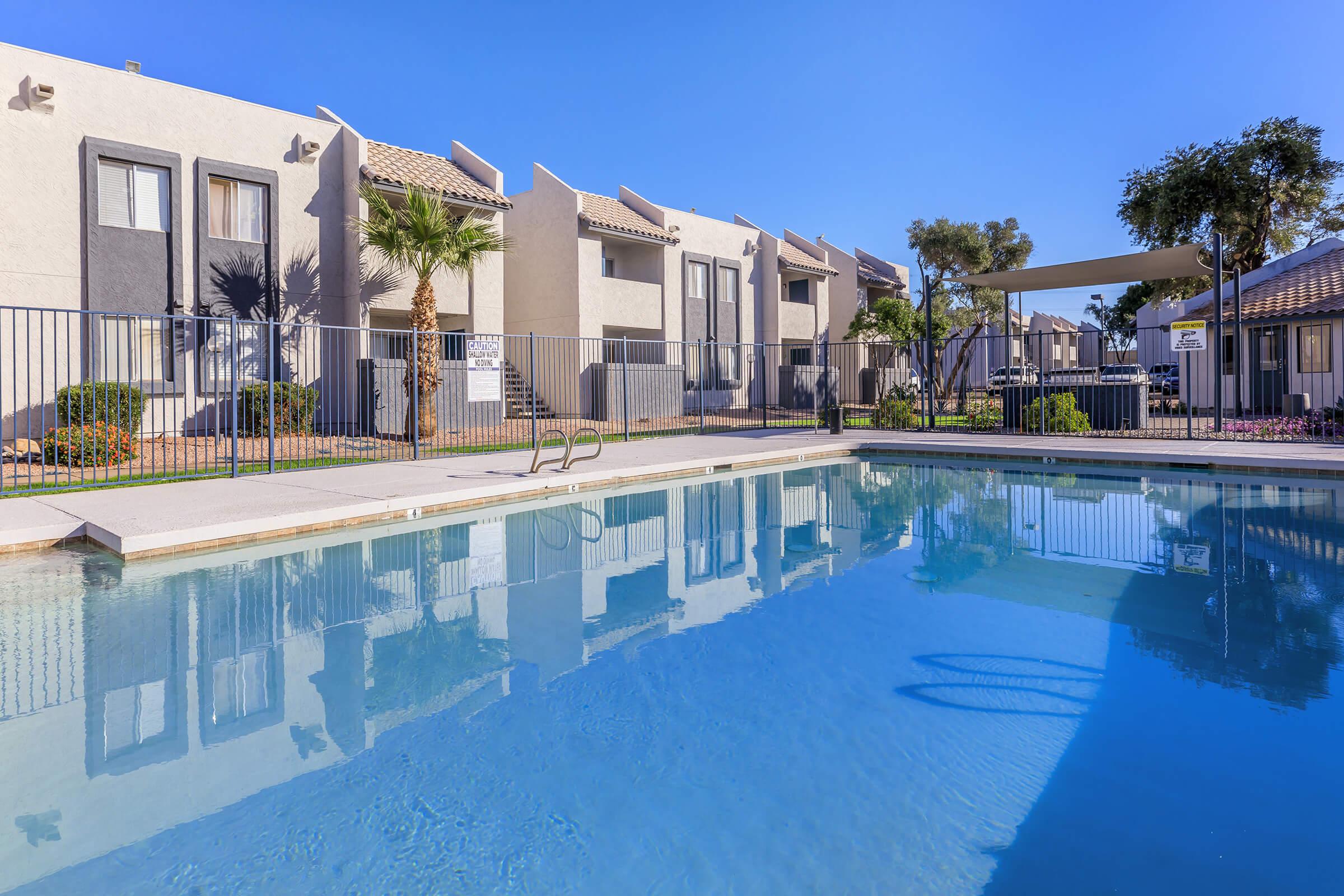 A dazzling pool surrounded by apartments at Rise Thunderbird.