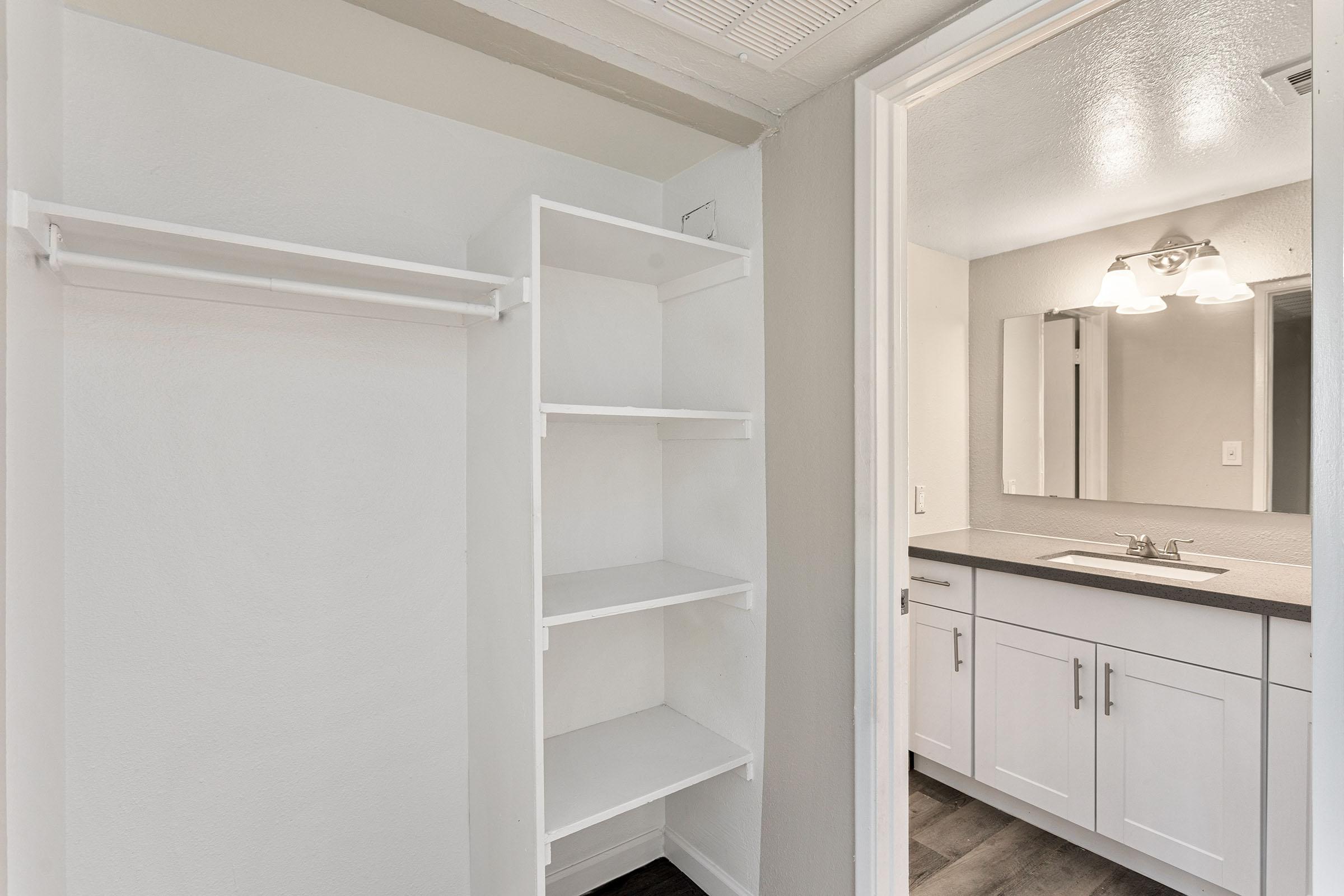 A large closet with shelving near the bathroom at Rise Thunderbird.