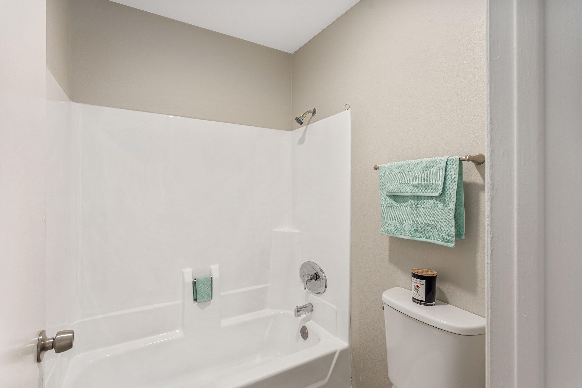 A bathroom with a tub and shower at Rise Thunderbird. 