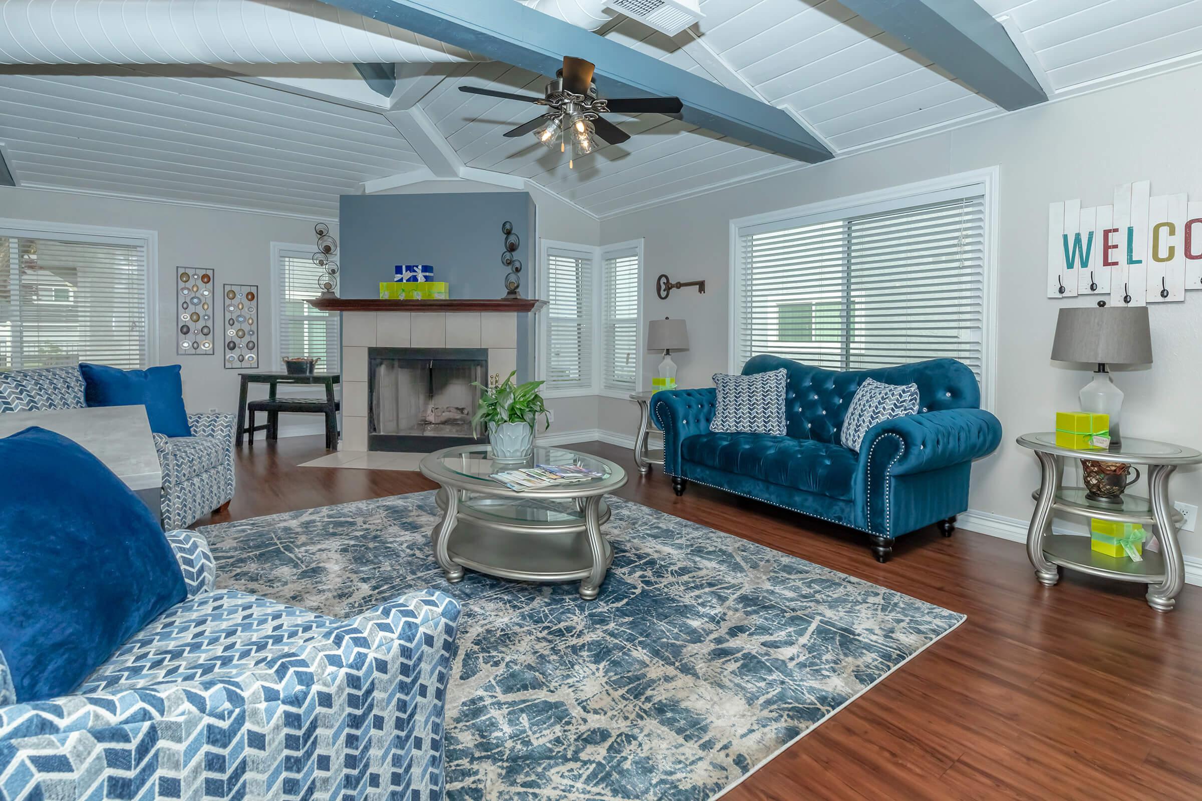 a living room filled with furniture and a large window