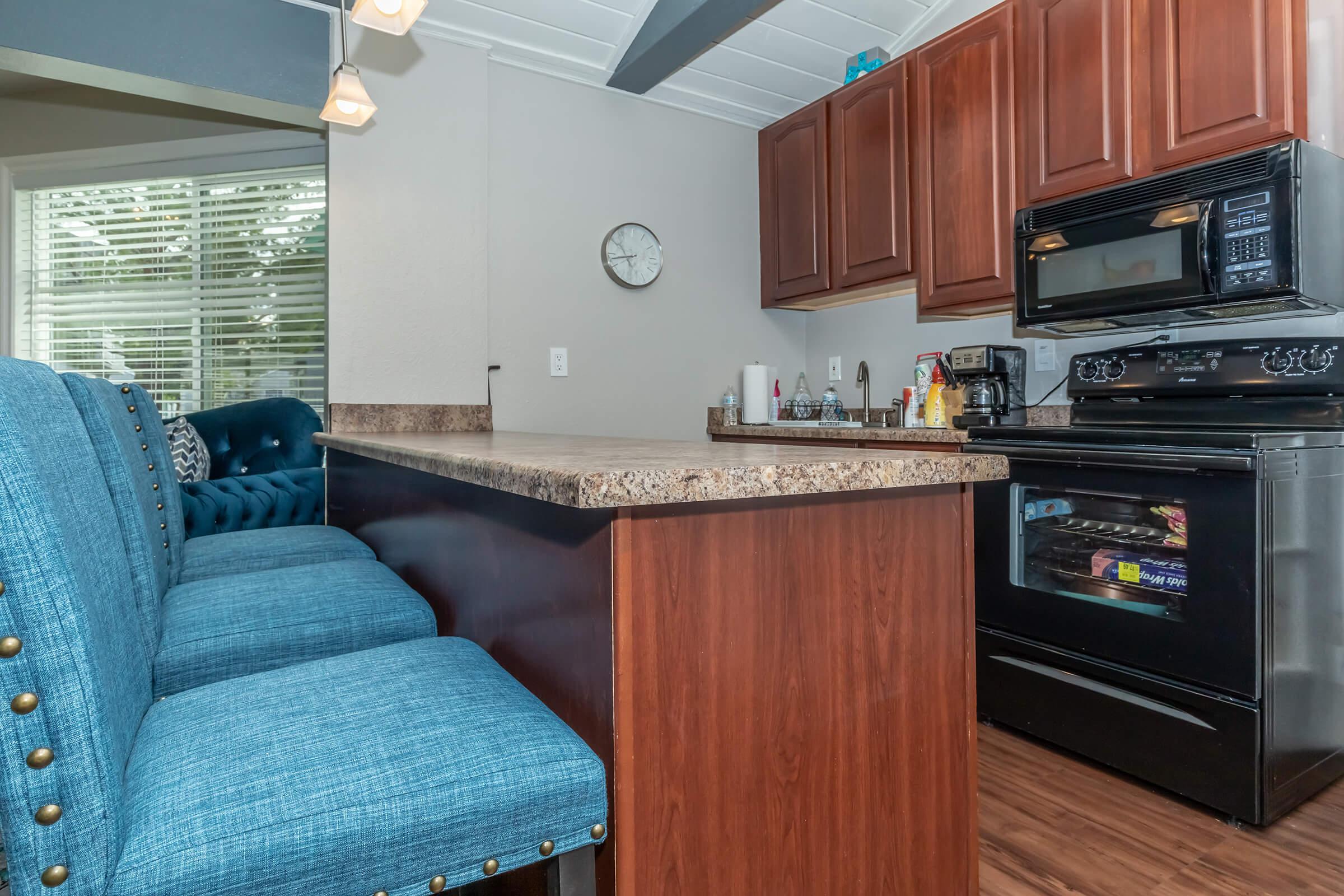 a kitchen with a stove top oven sitting inside of a room