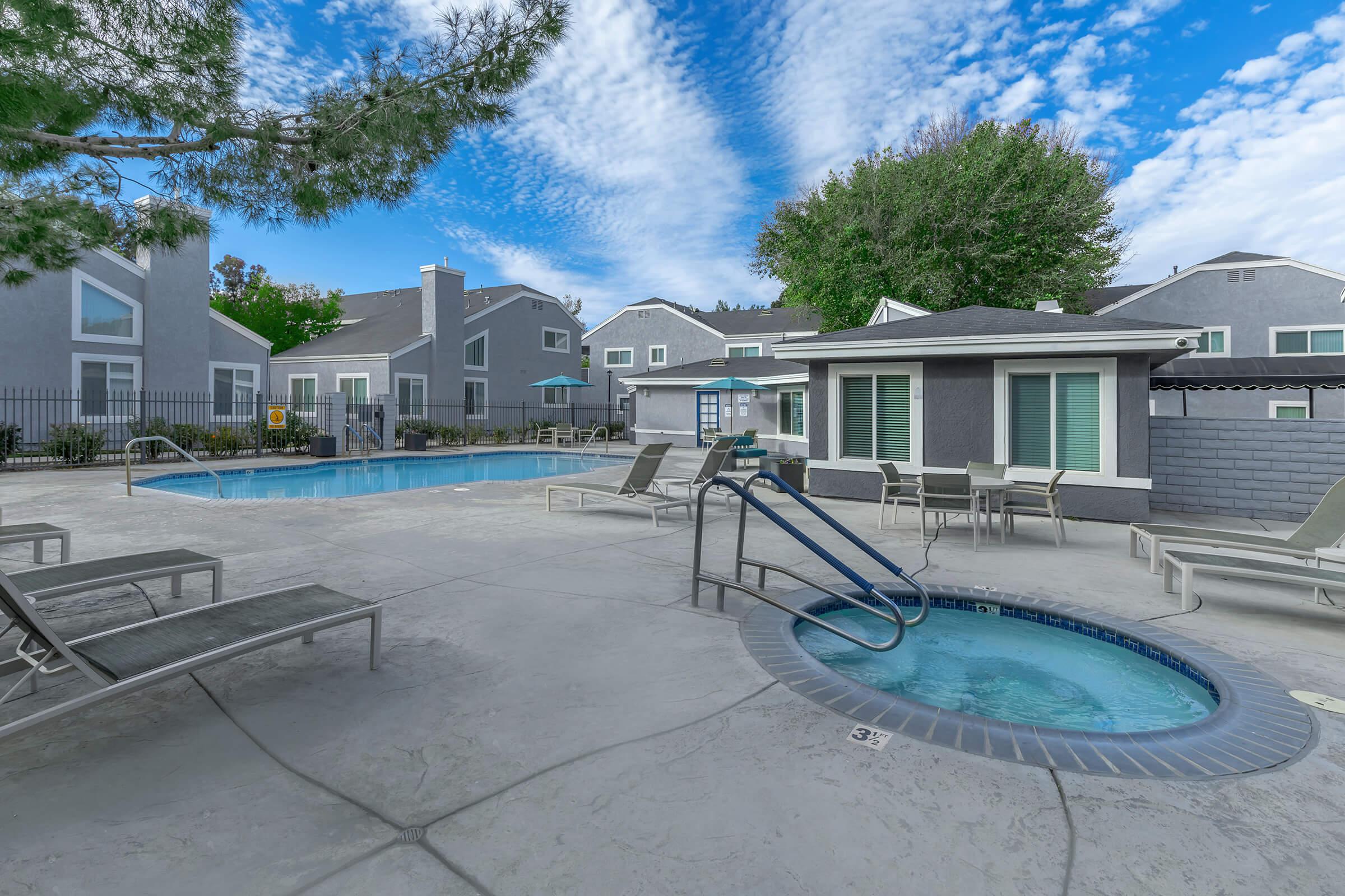 a house with a pool in front of a building