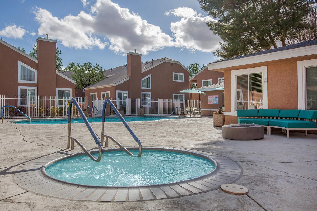 a house with a pool in front of a building