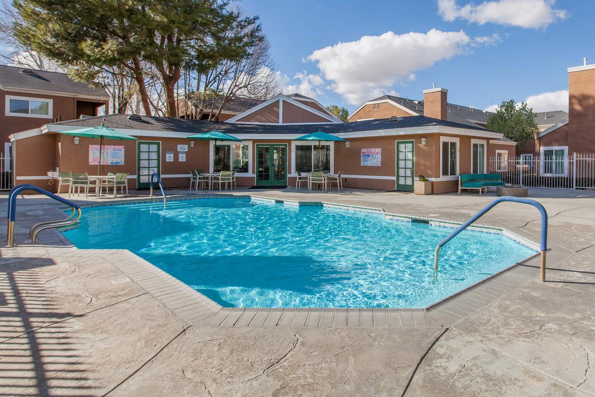 a house with a pool in front of a building