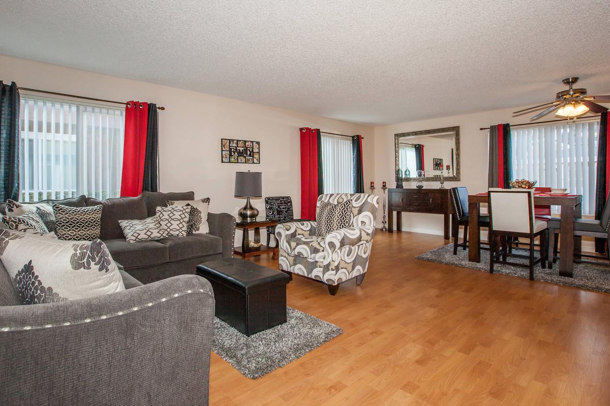 a living room filled with furniture and a flat screen tv