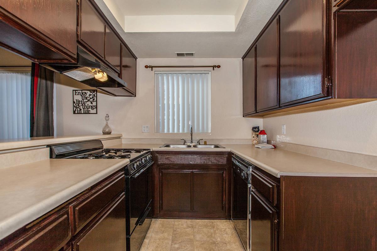 a kitchen with wooden cabinets and a window