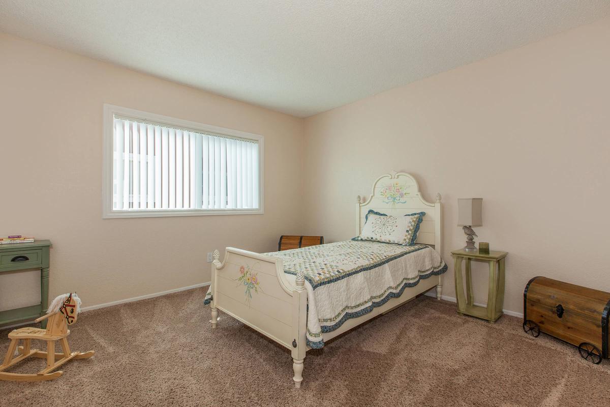 a bedroom with a bed in a room